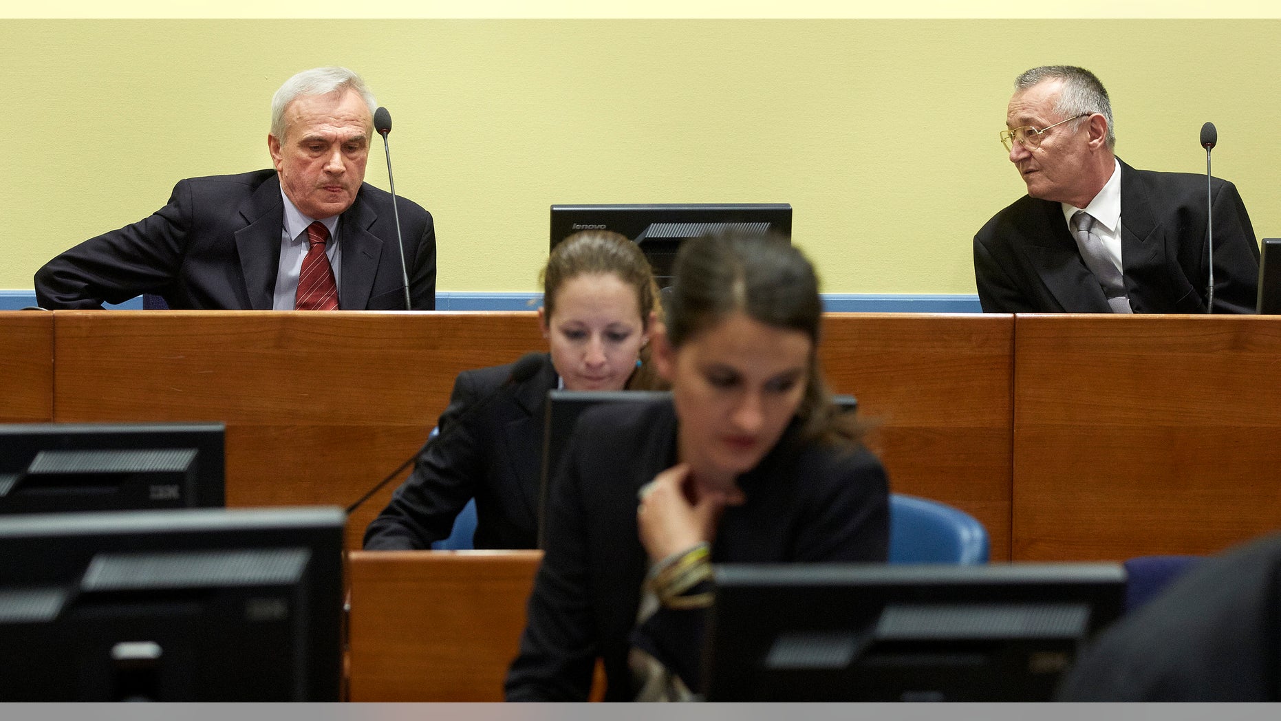 Former state security chief Jovica Stanisic, left, and former paramilitary leader Franko Simatovic, right, await their judgment at the Yugoslav war crimes tribunal (ICTY) in The Hague, Netherlands, Thursday May 30, 2013. The ICTY is set to deliver verdicts in the trial of two senior Serb security officials accused of supporting rebels who murdered Muslims and Croats in Bosnia's 1992-95 war. (AP Photo/Martijn Beekman, Pool)