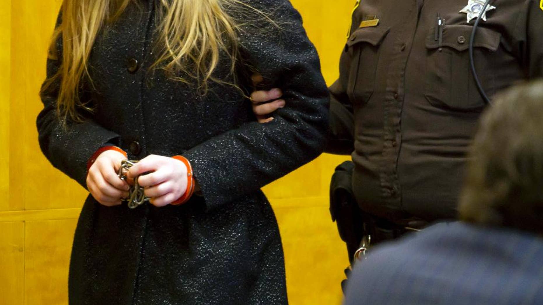 One of two 12-year-old girls accused of stabbing a classmate to please the fictional character Slender Man is led into a courtroom at the Waukesha County Courthouse in Waukesha, Wis. Tuesday, Nov. 18, 2014. Her attorney challenged a doctor's report that said she was competent to stand trial. A competency hearing was scheduled for Dec. 18, the same day as a competency hearing for the other girl accused in the case. (AP Photo/Waukesha Freeman, Charles Auer, Pool)