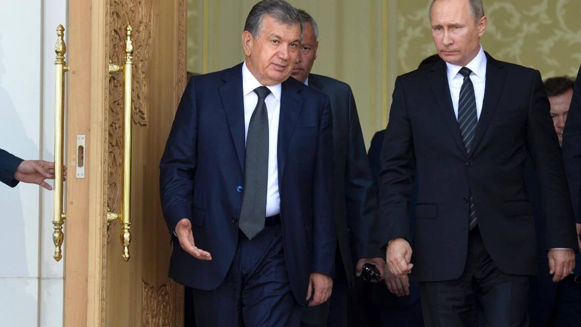 Uzbekistan's Prime Minister Shavkat Mirziyayev, left, speaks with Russian President Vladimir Putin in Samarkand, Uzbekistan, Tuesday, Sept. 6, 2016. Putin arrived to express his condolences and visit a grave of Uzbekistan's President Islam Karimov in Samarkand. (Alexei Druzhinin/Sputnik, Kremlin Pool Photo via AP)