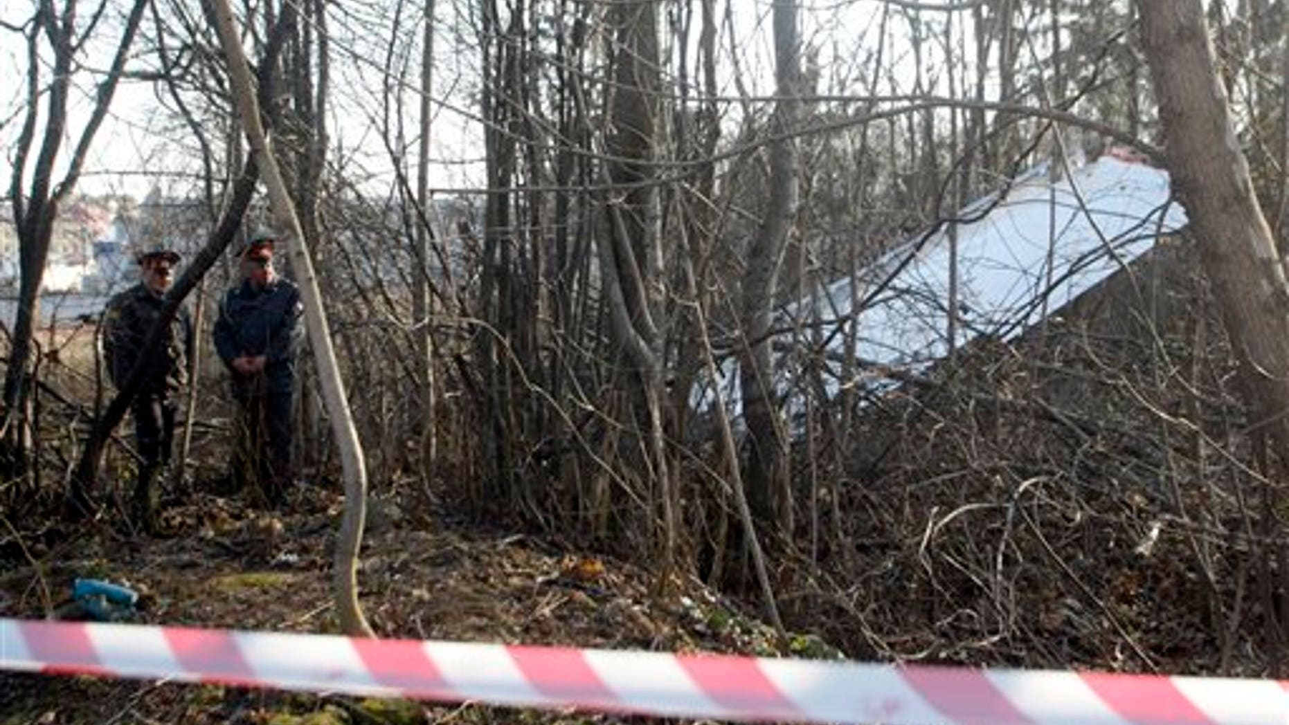 April 10: Russian police officers walk near some of the wreckage at the plane crash site near Smolensk, western Russia. Polish President Lech Kaczynski, his wife and some of the country's most prominent military and civilian leaders died along with dozens of others when the presidential plane crashed as it came in for a landing in thick fog near Smolensk in western Russia.