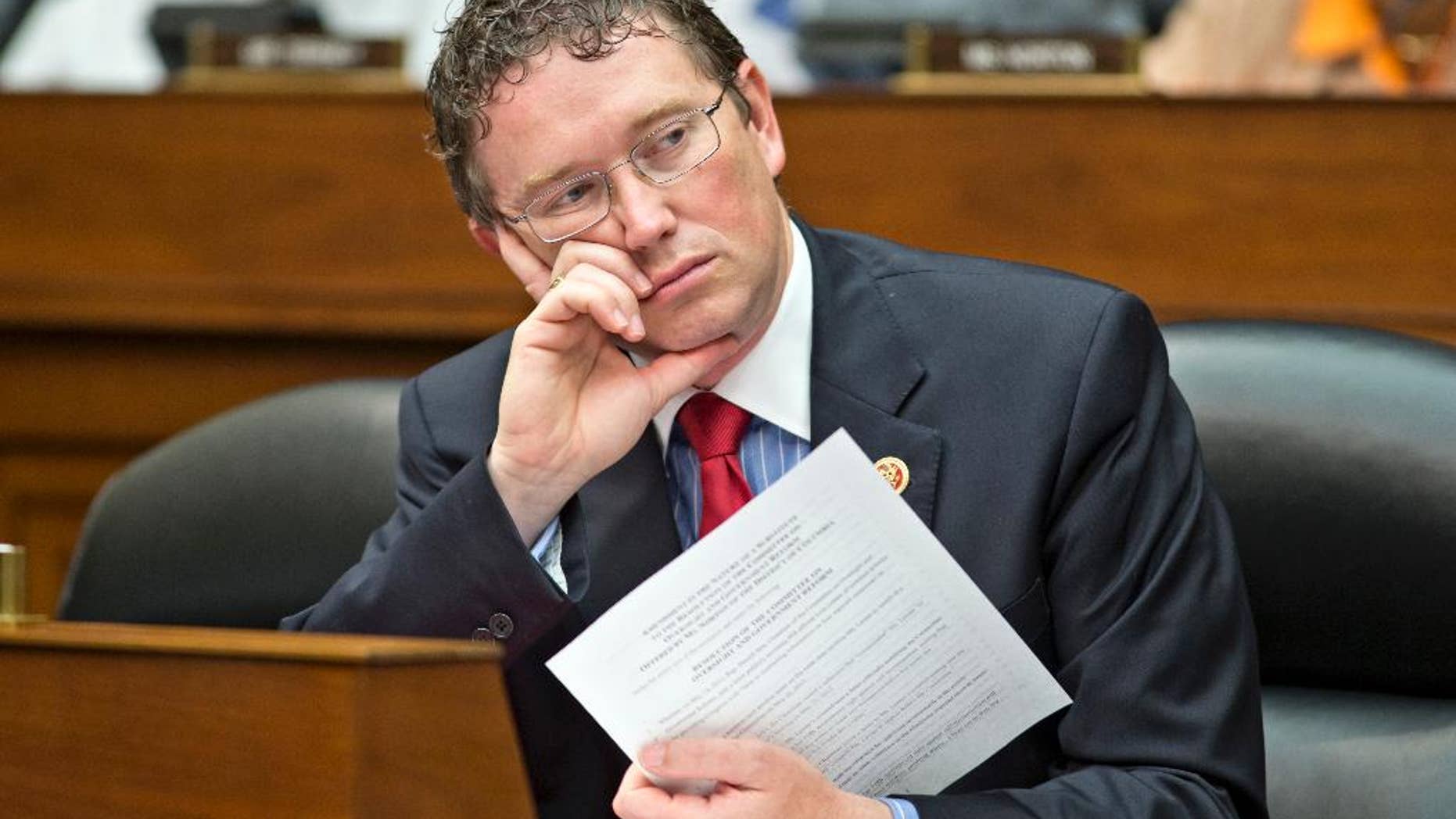 FILE - In this June 28, 2013, file photo, Rep. Thomas Massie, R-Ky., listens during a House Oversight Committee hearing on Capitol Hill in Washington. A vocal group of congressional Republicans, including Massie, and Democrats are reprimanding President Donald Trump for launching the cruise missile attack against Syria without first getting Capitol Hill’s approval. (AP Photo/J. Scott Applewhite, File)