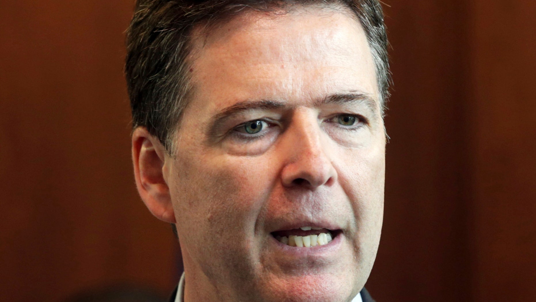 FILE - In this June 17, 2014, file photo, FBI Director James Comey addresses a news conference at the FBI Minneapolis field office in Brooklyn Center, Minn.