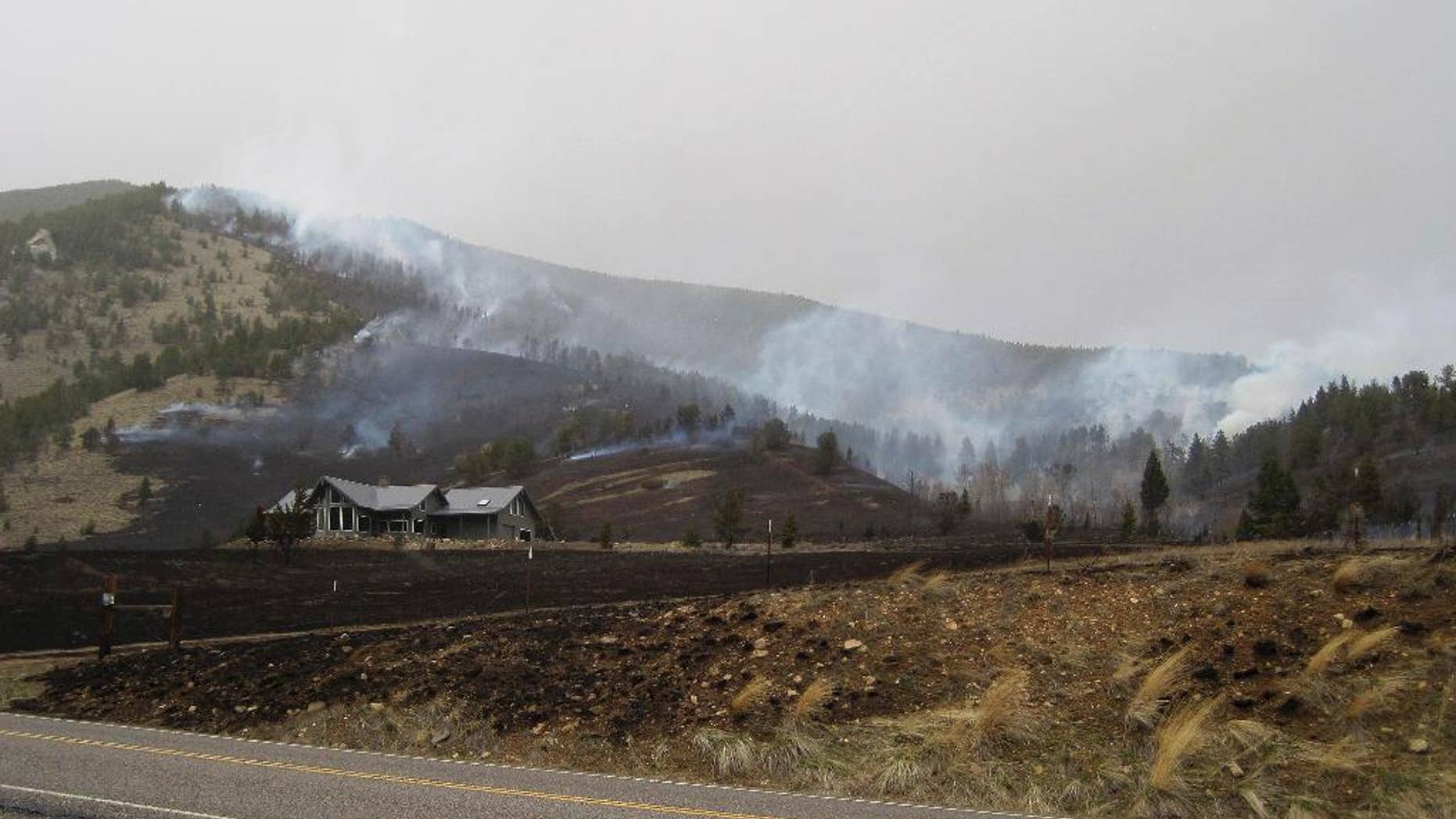 In this photo released by the U.S. Forest Service, the Wildland Fire burns along Nichols Creek Saturday, March 28, 2015, near Red Lodge, Montana. Authorities evacuated a ski lodge in southern Montana because of a wind-driven wildfire heading toward it. The wildfire was reported about 1:45 p.m. Saturday and had burned an estimated 200 acres of grass and timber about 4 miles west of the community of Red Lodge. The fire began on open private land, but it was driven by winds gusting 35 to 50 mph into the Custer National Forest, where the Red Lodge Mountain Resort ski area is located. (AP Photo/U.S. Forest Service)