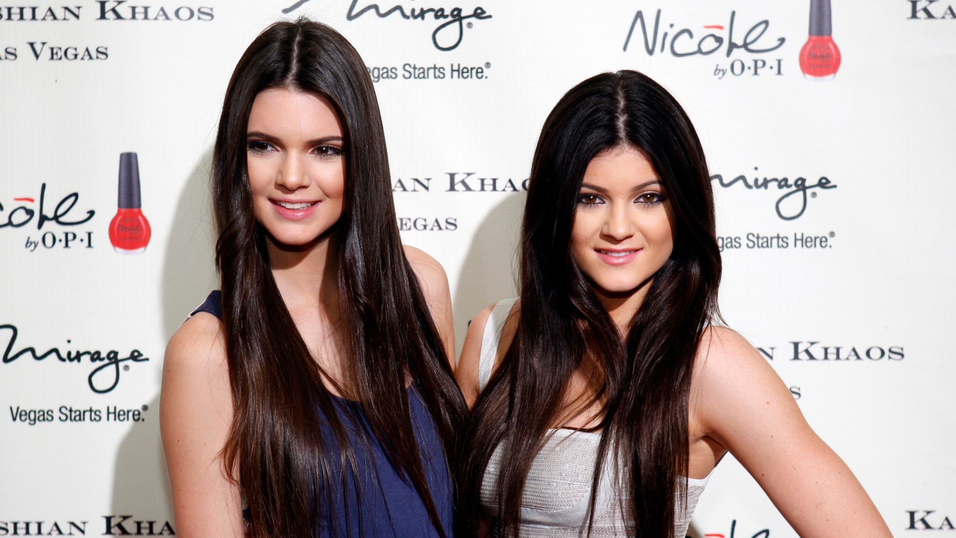 Television personalities Kendall Jenner (L) and younger sister Kylie Jenner arrive at the grand opening of the Kardashian Khaos store at the Mirage Hotel and Casino in Las Vegas, Nevada December 15, 2011.