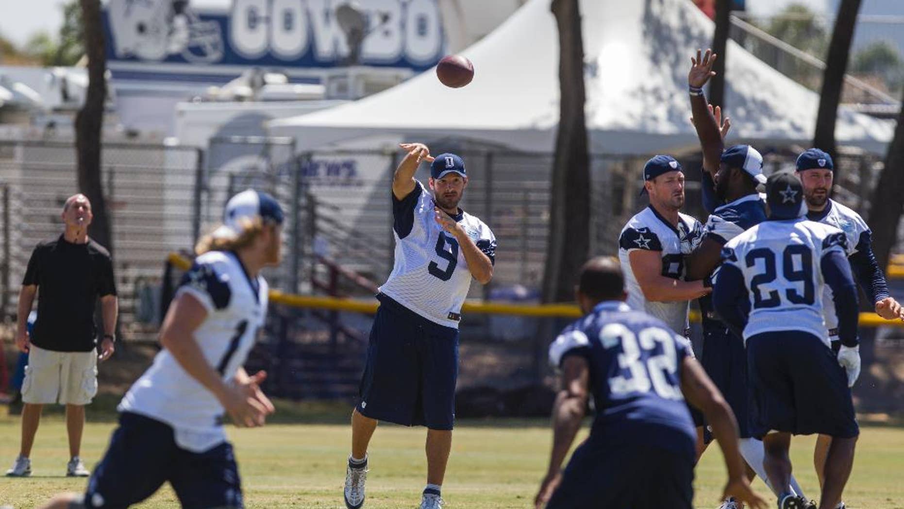 Dallas Cowboys quarterback Tony Romo (9) throws a pass during a morning practice at NFL football training camp, Thursday, July 31, 2014, in Oxnard, Calif. (AP Photo/Ringo H.W. Chiu)