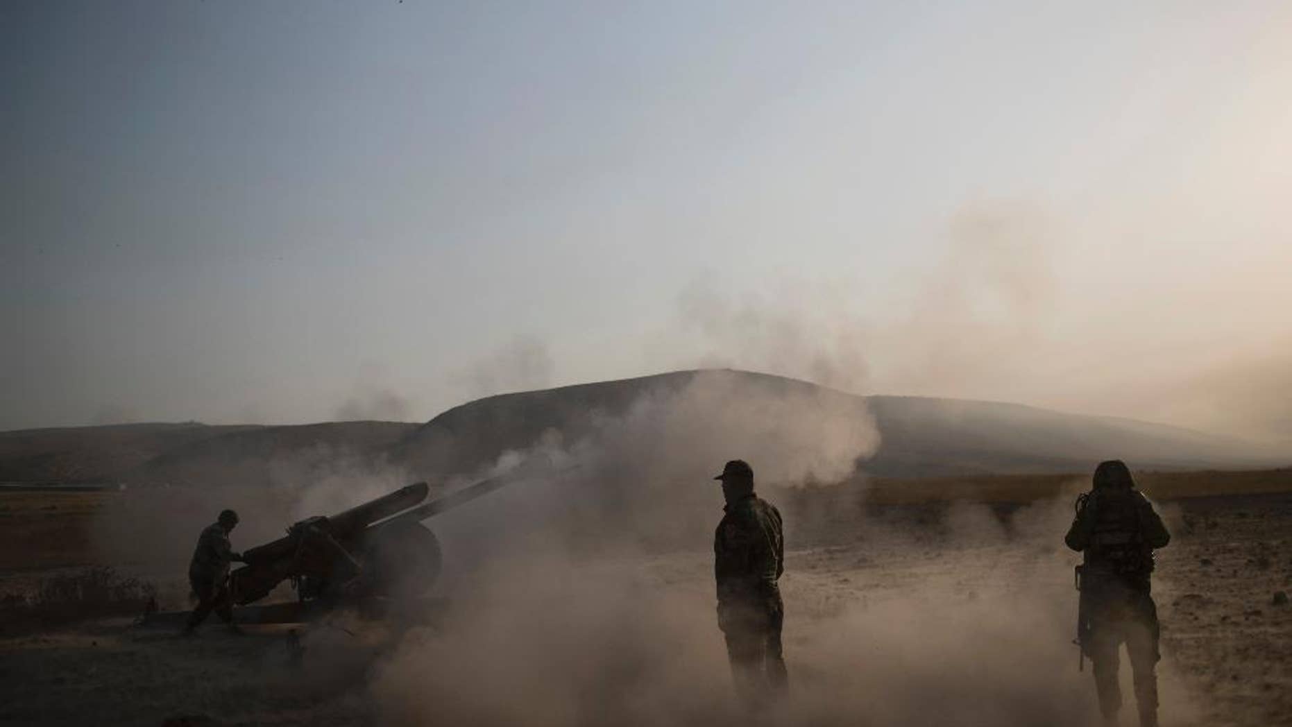 Kurdish Peshmerga soldiers fire artillery at Islamic State positions in Bashiqa, east of Mosul, Iraq, Monday, Nov. 7, 2016. Iraqi Kurdish fighters exchanged heavy fire with IS militants early on Monday as they advanced from two directions on a town held by the Islamic State group east of the city of Mosul. (AP Photo/Felipe Dana)