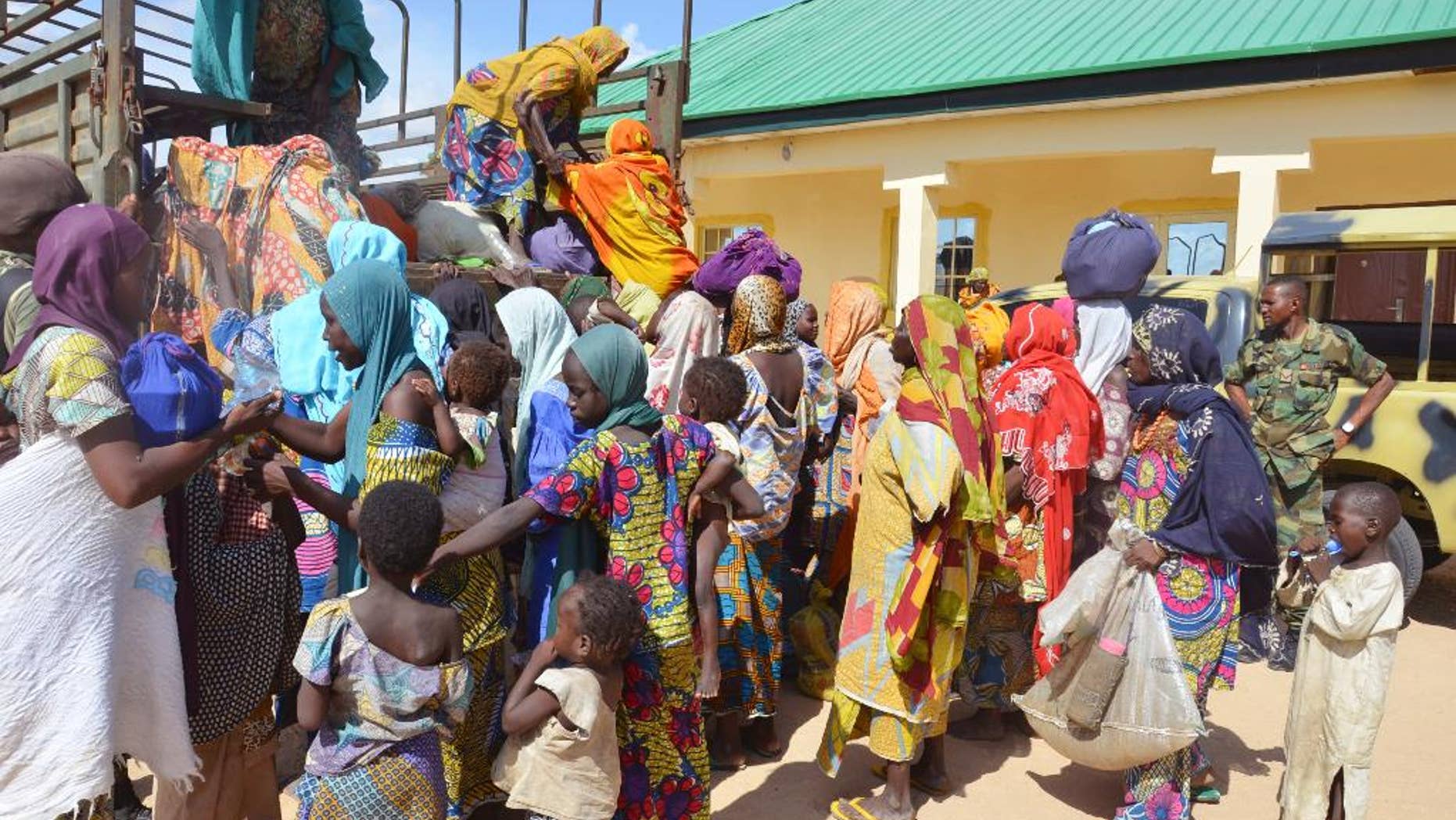 FILE- In this Thursday, July. 31, 2015 file photo, women and children rescued by Nigerian soldiers from Boko Haram extremists in the northeast of Nigeria arrive at the military office in Maiduguri. Nigerian troops rescued 178 people from Boko Haram in attacks that destroyed several camps of the Islamic extremists in the northeast of the country, an army statement said Sunday, Aug. 2. Spokesman Col. Tukur Gusau said that 101 of those freed are children, along with 67 women and 10 men. (AP Photo/Jossy Ola file)