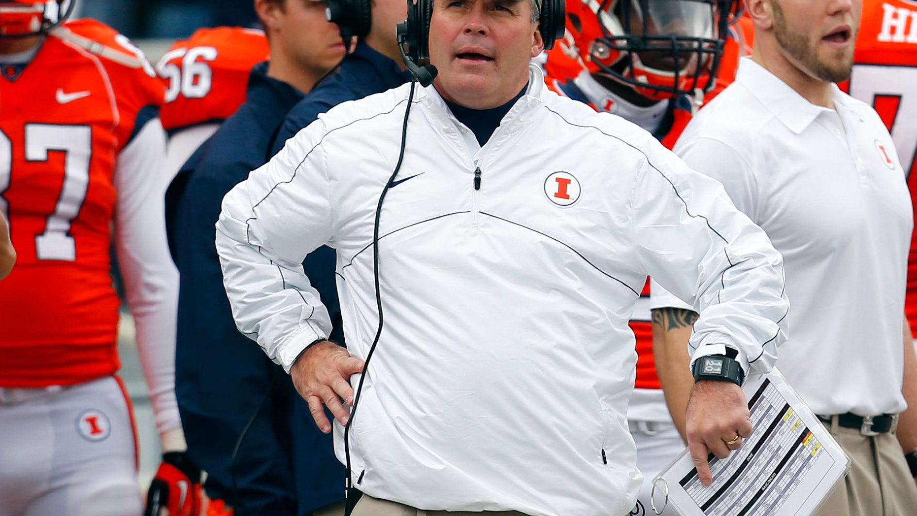 FILE - In this Nov. 16, 2013 file photo, Illinois head coach Tim Beckman watches a replay during the first half of an NCAA college football game against Ohio State in Champaign, Ill. Illinois confirmed Monday, Dec. 2, 2013 that Beckman will be back for a third season in 2014. Speculation about the second-year head coach's job security followed him through much of the 4-8 season that ended with the Saturday, Nov. 30 loss to Northwestern. (AP Photo/Jeff Haynes, File)