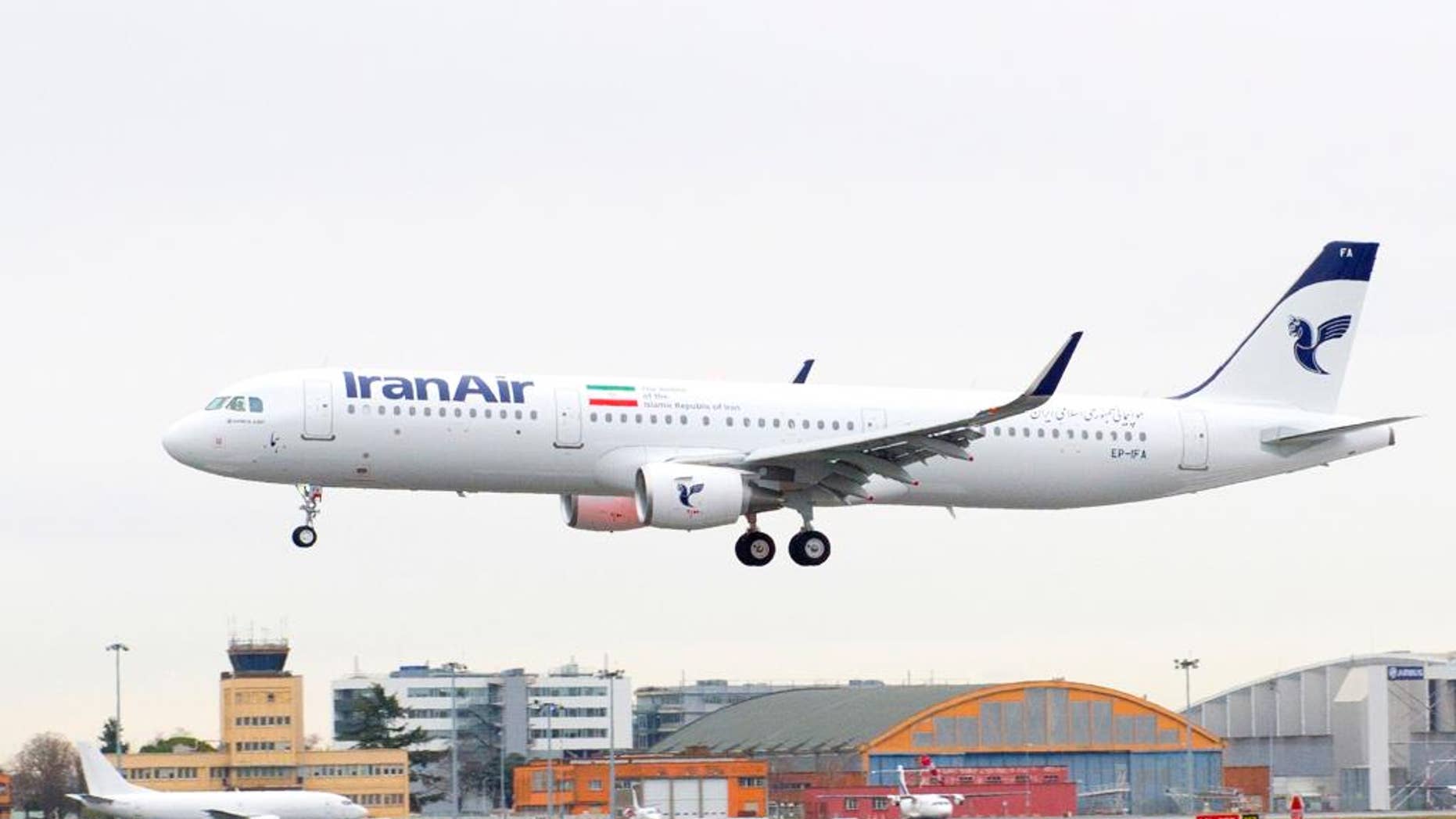 In this photo dated Wednesday, Jan. 11, 2016, provided by Airbus, shows an A321 with the Iran Air logo landing at Blagnac airport near Toulouse, southwestern France. Iran Air has taken delivery of its first new aircraft, an A321, in a hand over ceremony in Toulouse. (Herve Gousse/Airbus via AP) MANDATORY CREDIT