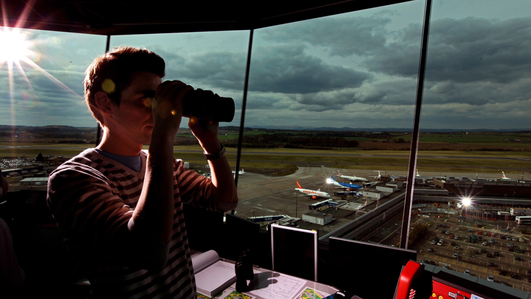 EDINBURGH, UNITED KINGDOM - APRIL 19: Greig Reid an air traffic controller looks from the air traffic control tower at Edinburgh Airport as flights are cancelled for a fifth day on April 19, 2010 in Edinburgh, Scotland. Thousand of holiday makers remain stranded abroad as the ban on flight to and from UK airport because of volcanic dust continues. (Photo by Jeff J Mitchell/Getty Images)
