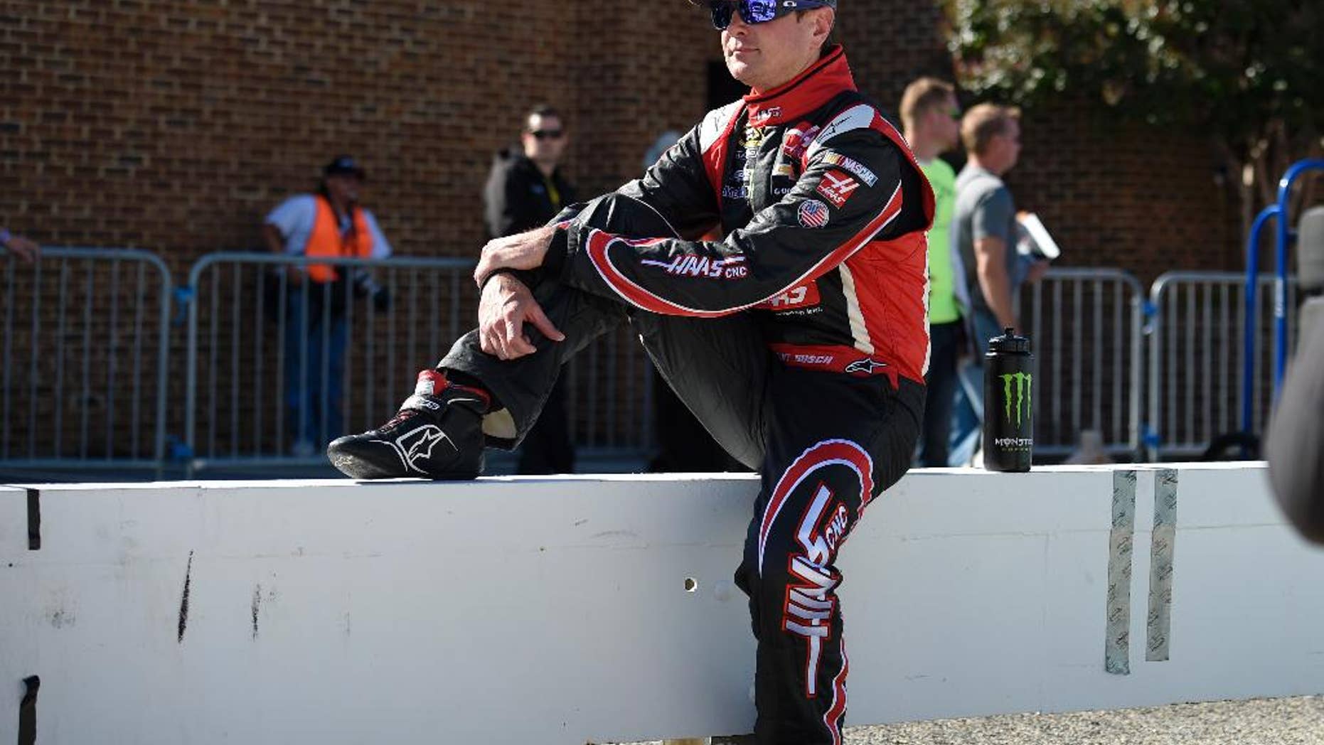 Kurt Busch looks on before qualifying for a NASCAR Sprint Cup series auto race, Friday, Sept. 26, 2014, at Dover International Speedway in Dover, Del. (AP Photo/Nick Wass)