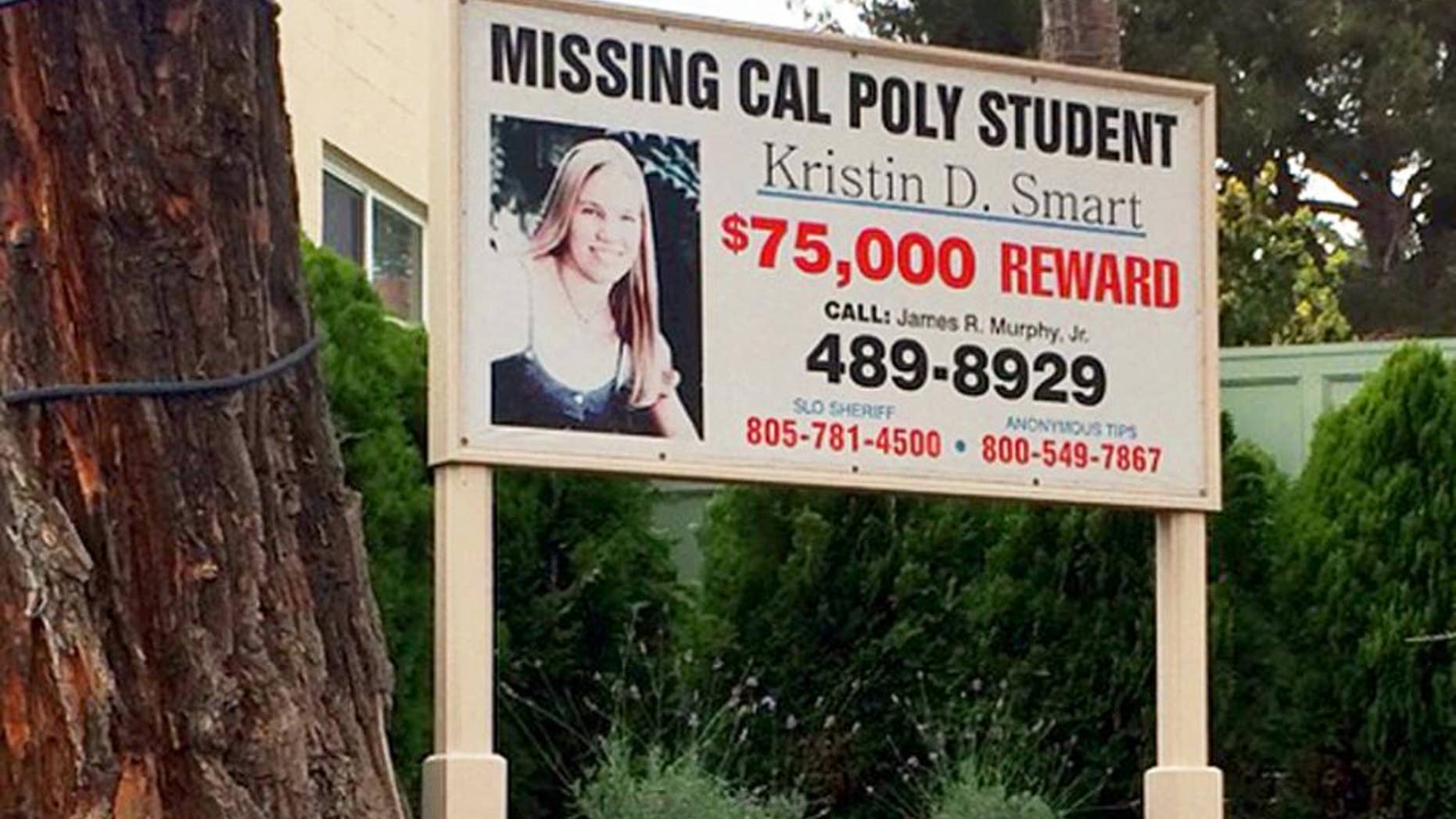 A sign outside the James R. Murphy, Jr. law office in Arroyo Grande, Calif., offers a reward for information in the 1996 disappearance of Kristin Smart, Wednesday, Sept. 7, 2016. FBI agents sifted through dirt Wednesday at an excavation site on the edge of California Polytechnic State University, San Luis Obispo, where they hope to find remains of the student. Smart, 19, of Stockton, Calif., was last seen in the early morning of May 25, 1996, while returning to her dorm after an off-campus party. (AP Photo)