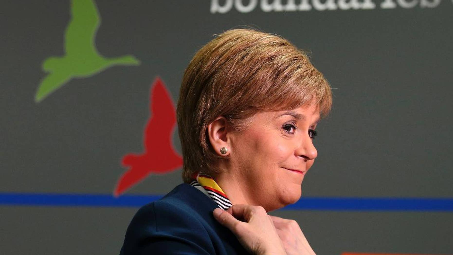 Scotland's First Minister Nicola Sturgeon smiles as she visits Genpact, an Indian multinational company, where she announced new jobs for Scotland Wednesday March 29, 2017. Scottish lawmakers have voted to seek a new referendum on independence, to be held within the next two years. The Scottish parliament on Tuesday voted 69-59 to authorize First Minister Nicola Sturgeon to ask the British government for an independence vote. (Andrew Milligan/PA via AP)