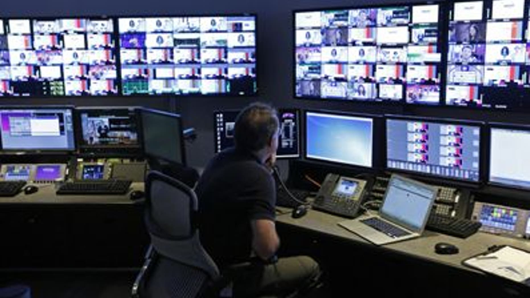 A technician works in the "Acquisition Room", which receives television feeds from around the world.
