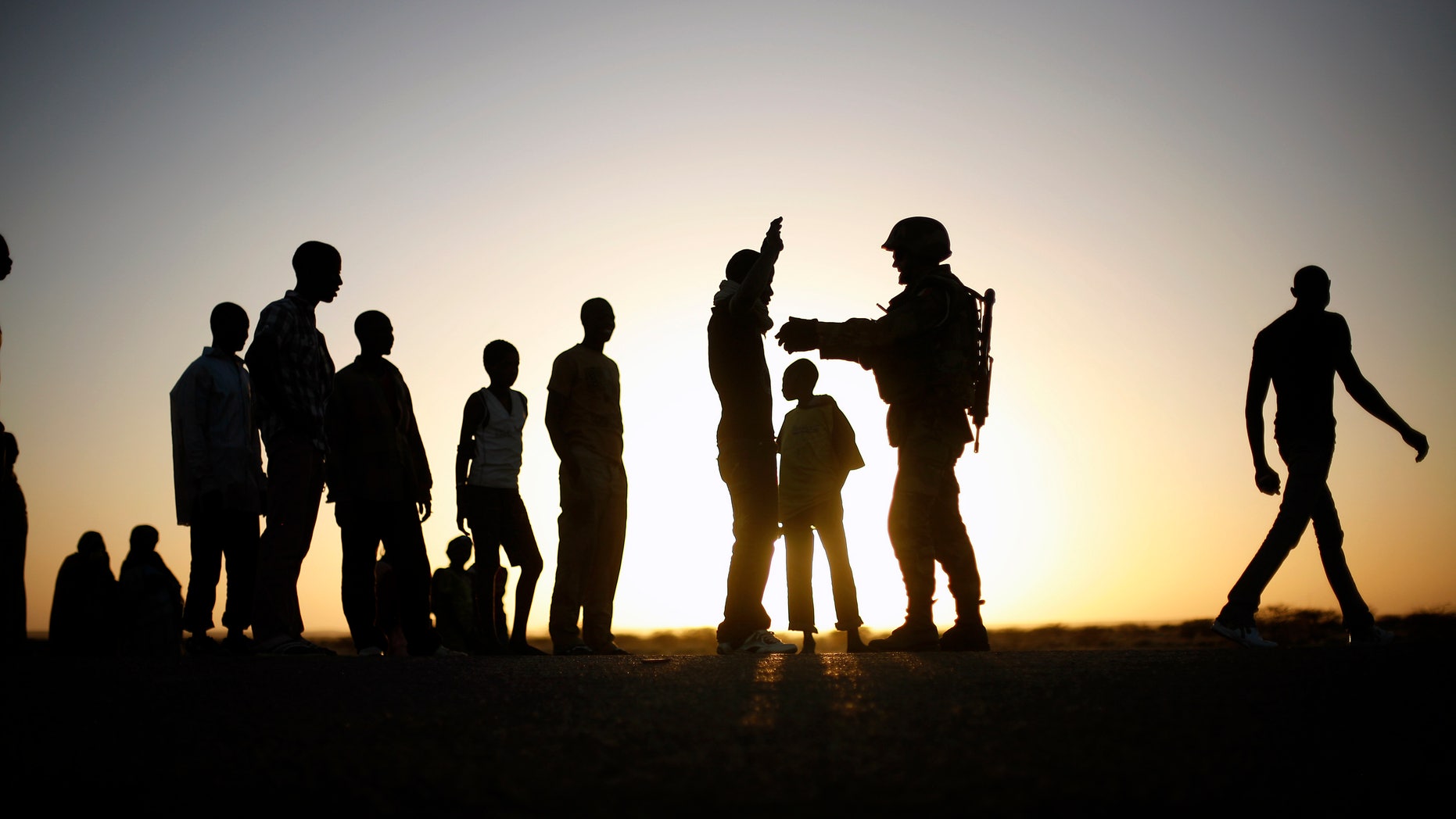 A French soldier checks passengers of a transport truck arriving in Gao, northern Mali, Thursday Feb. 14, 2013. Malian forces have stepped up security around the port an the main market, in an effort to stop the infiltration of rebel fighters in the town. (AP Photo/Jerome Delay)