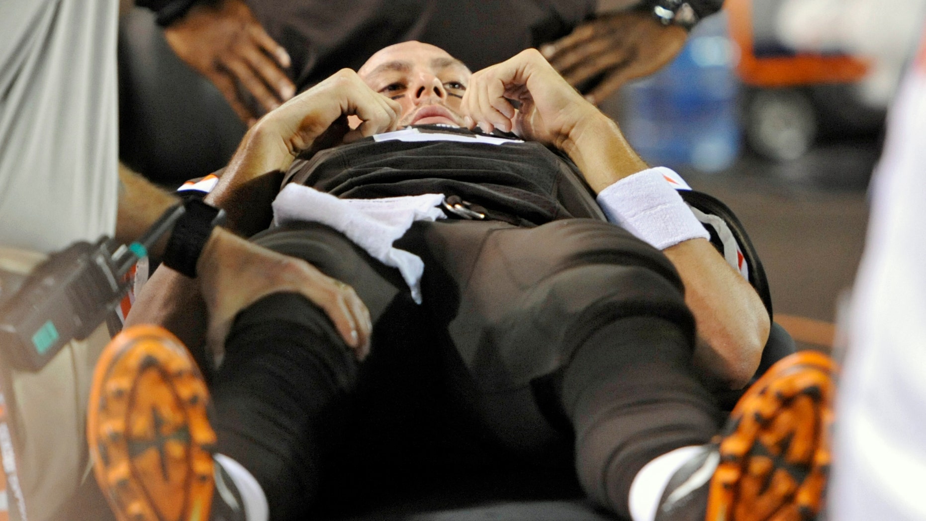 Cleveland Browns quarterback Brian Hoyer is treated on the sidelines after an injury to his right knee in the first quarter of an NFL football game against the Buffalo Bills on Thursday, Oct. 3, 2013, in Cleveland. Brandon Weeden took over as Hoyer was taken to the locker room. (AP Photo/David Richard)