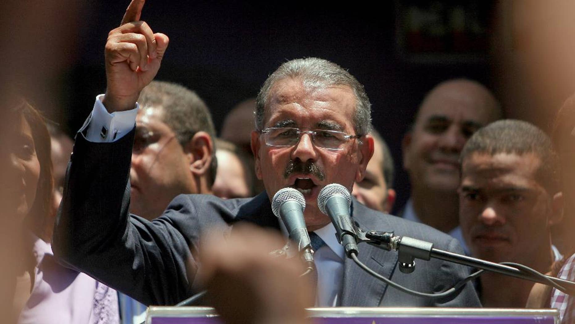 FILE - In this May 21, 2012 file photo, Dominican President-elect Danilo Medina thanks his supporters for a first-round election win, at his party headquarters in Santo Domingo, Dominican Republic. Medina said late Wednesday, June 17, 2015 that he's open to running for re-election, comments that come nearly a week after approval of a constitutional reform that lets presidents seek two consecutive terms. (AP Photo/Ricardo Arduengo, File)