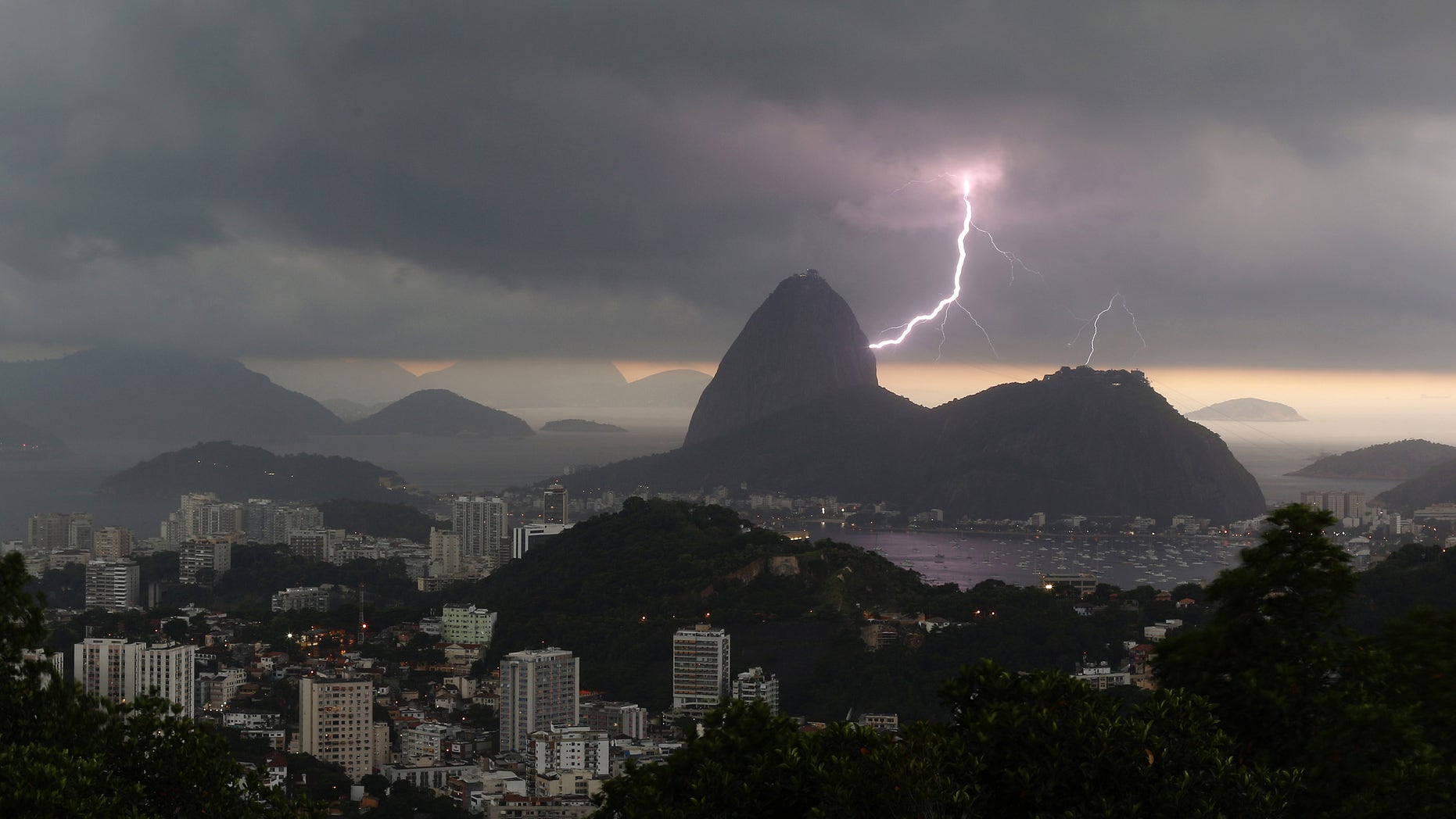 Lightning lights up the the sky over Sugar Loaf mountain in Rio de Janeiro, Brazil, Thursday, Jan.16, 2014. An alert was called by Rio authorities due to heavy rains and the possibilty of floods in the city. (AP Photo/Leo Correa)