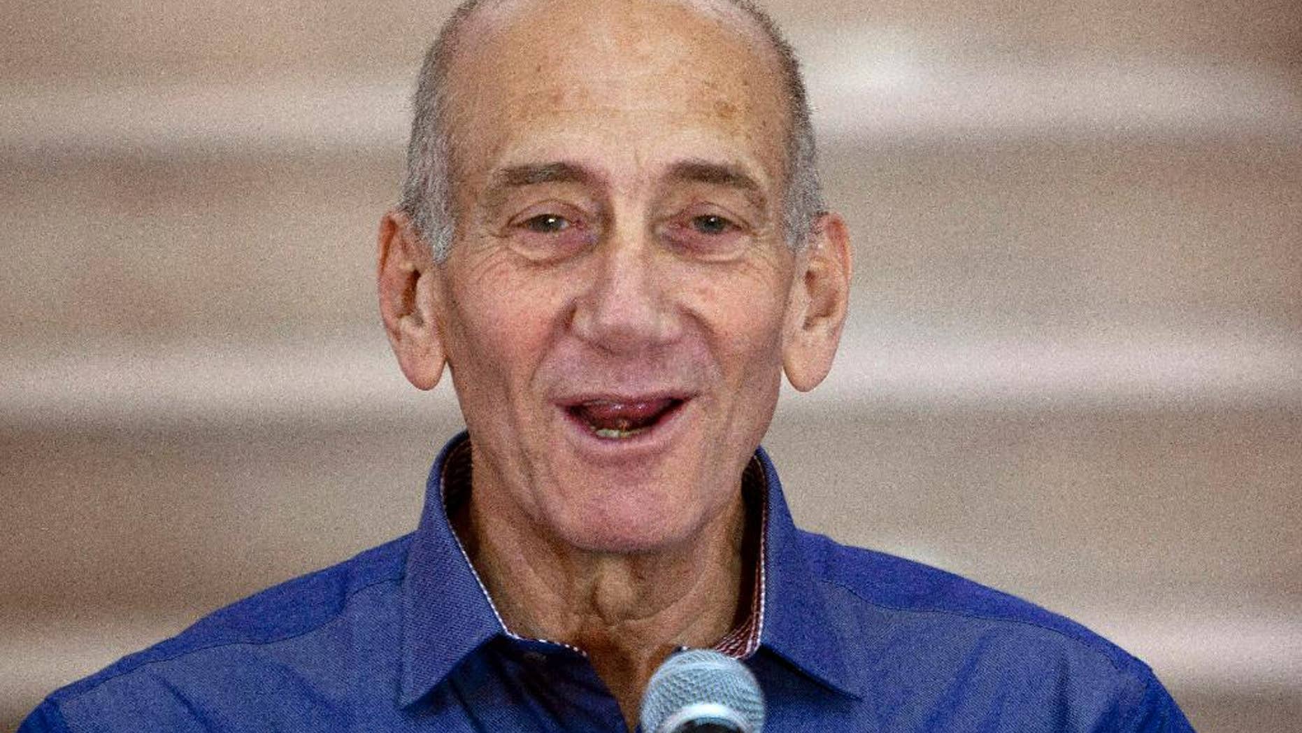 FILE - In this Tuesday, July 10, 2012 file photo, Former Israeli Prime Minister Ehud Olmert speaks to the media after hearing the verdict in his trial, in Jerusalem's District Court. Israel’s Supreme Court on Monday postponed the start of Olmert’s prison sentence pending appeal on his conviction on corruption charges. (AP Photo/Ariel Schalit, File)