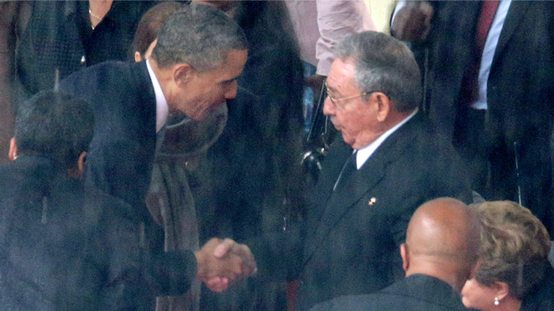 Obama and Castro during the official memorial service for former South African President Nelson Mandela December 10, 2013.