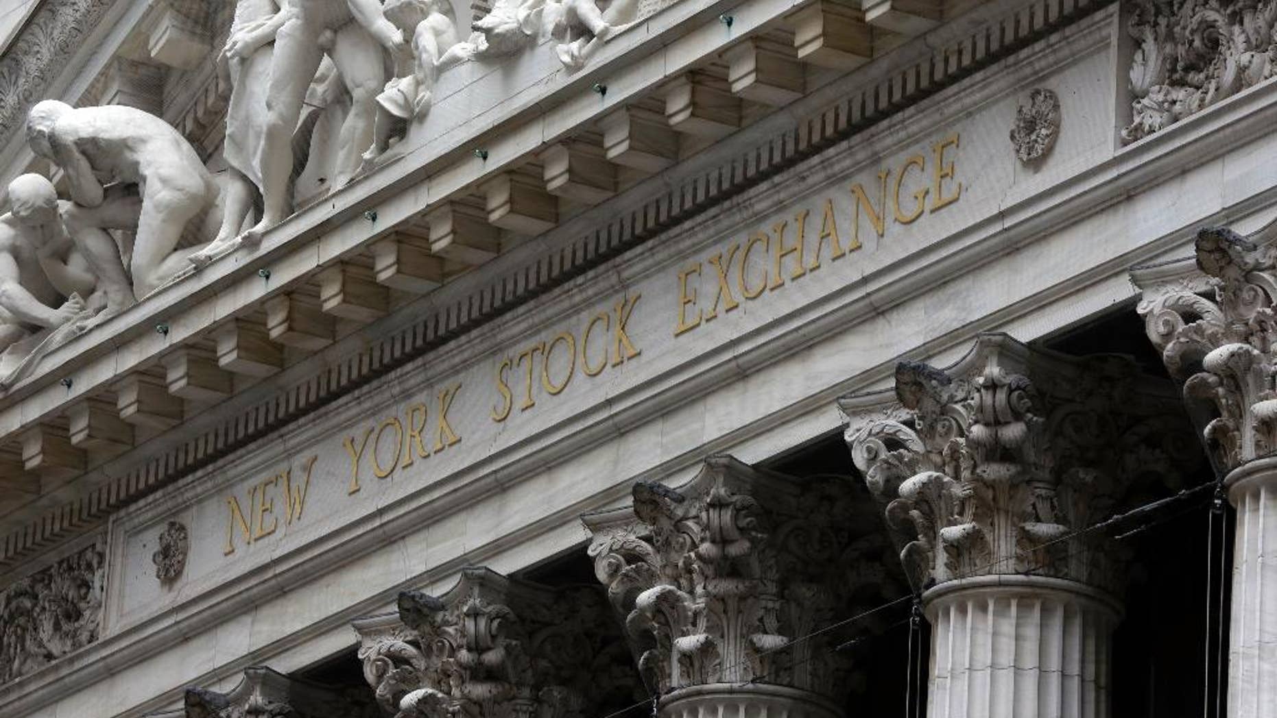 FILE - This Oct. 2, 2014 file photo shows the facade of the New York Stock Exchange, in New York. U.S. stocks opened higher Wednesday, April 8, 2015, as investors waited for the release of minutes from the Federal Reserve's latest meeting. Investors were also waiting for companies to start reporting their first-quarter earnings. Alcoa, a metals company, will be one of the first major companies to report earnings after the close of the market. (AP Photo/Richard Drew, File)