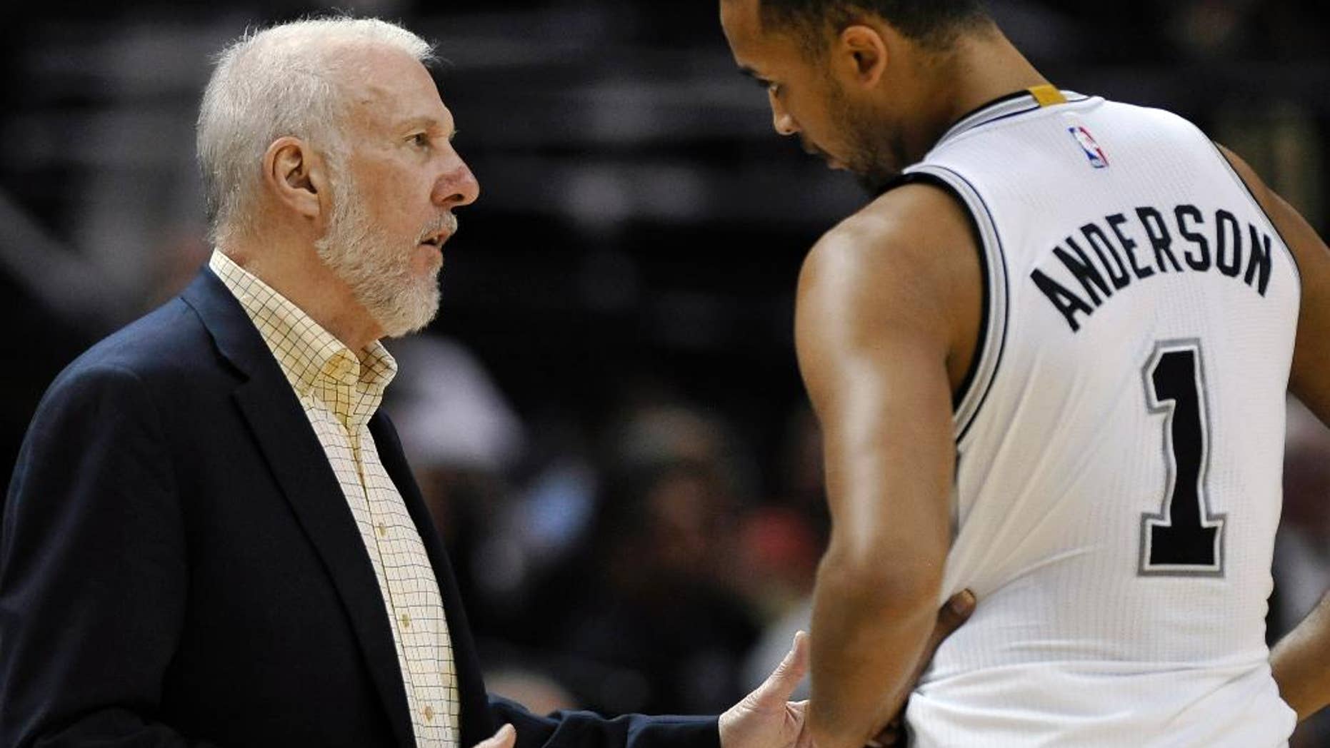San Antonio Spurs coach Gregg Popovich, left, talks with forward Kyle Anderson during the second half of a preseason NBA basketball game against the Miami Heat, Saturday, Oct. 18, 2014, in San Antonio. (AP Photo/Darren Abate)