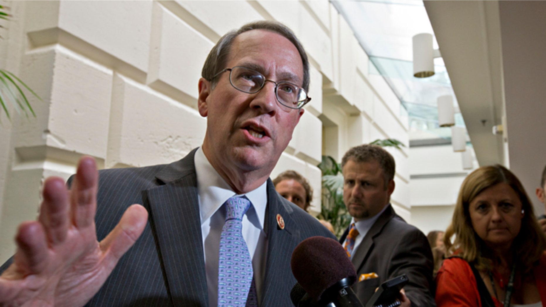 FILE - In this July 10, 2013, file photo House Judiciary Committee Chairman Bob Goodlatte,R-Va., speaks with reporters after House Republicans worked on an approach to immigration reform in a closed-door meeting at the Capitol in Washington. A central question is whether the 11 million immigrants already in the US illegally should get a path to citizenship. "We think a legal status in the United States, but not a special pathway to citizenship, might be appropriate," says Goodlatte. He has said that after attaining legal status, immigrants could potentially use the existing avenues toward naturalization, such as family or employment ties. (AP Photo/J. Scott Applewhite)