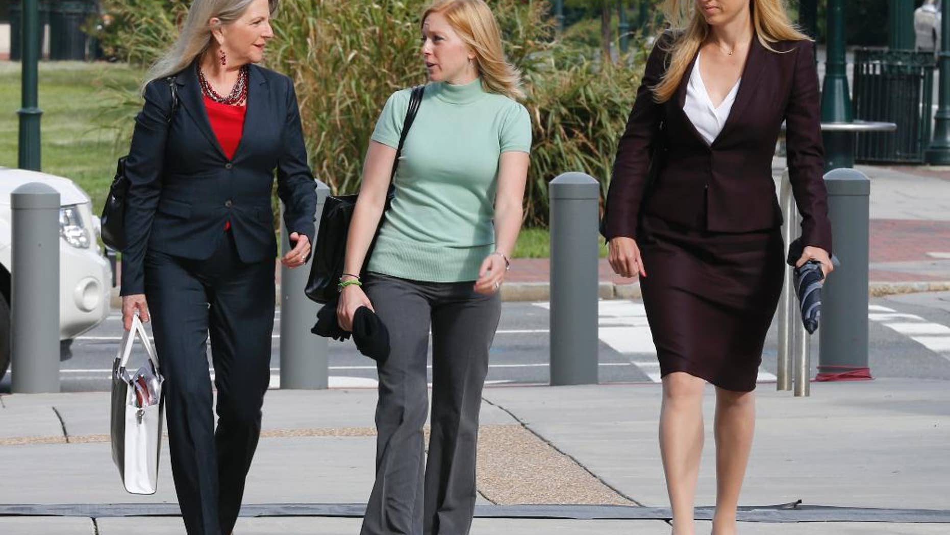 Former Virginia first lady, Maureen McDonnell, left, talks with her Daughter Cailin Young, center, and her attorney Heather Martin, as they arrive at federal court in Richmond, Va., Tuesday, Aug. 19, 2014. The McDonnells are presenting the second day of his defense on corruption charges. (AP Photo/Steve Helber)