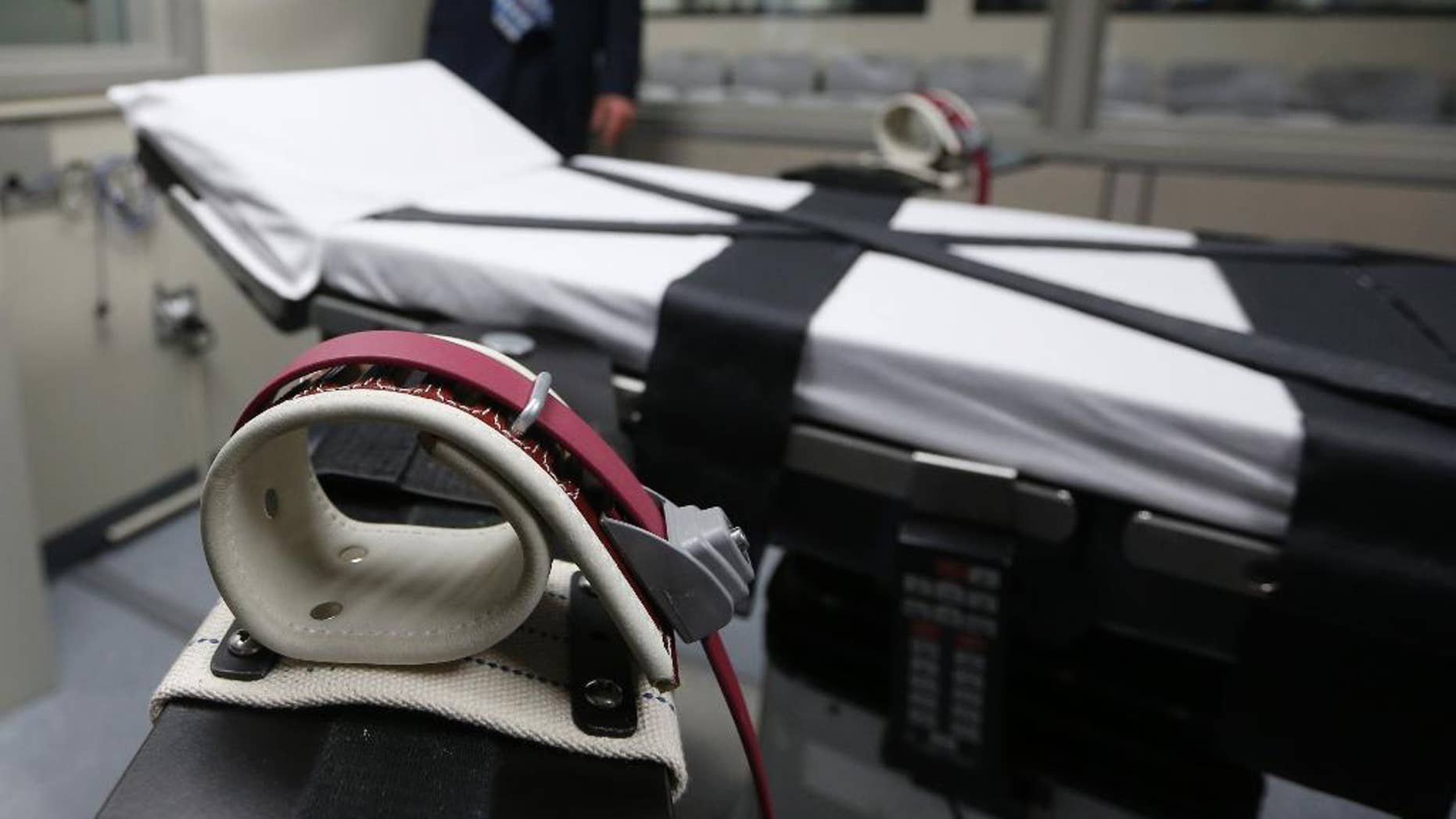 File - This Oct. 9, 2014 file photo, shows an arm restraint on the gurney in the the execution chamber at the Oklahoma State Penitentiary in McAlester, Okla. Attorneys for 21 death row inmates who will be in a federal court this week challenging Oklahoma's lethal injection procedure outlined their strategy in court documents that reveal grisly new details in the botched execution of an inmate in April, 2014. (AP Photo/Sue Ogrocki, File)