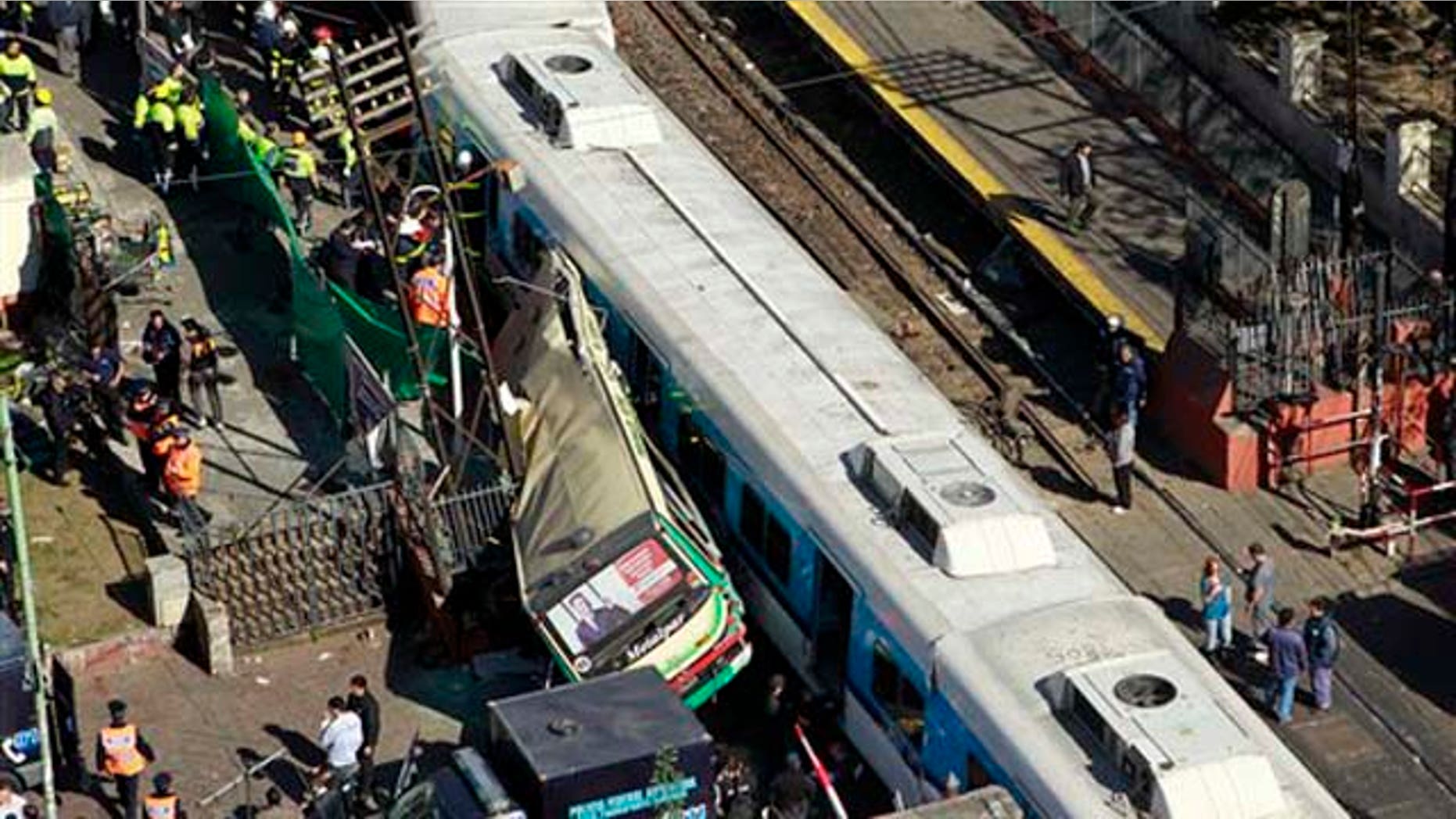 View of a crash between two passenger trains and a bus in Buenos Aires, Argentina, Tuesday, Sept. 13, 2011. At least seven people were killed and over 162 injured in a rush-hour crash involving two trains and a bus whose driver drove around barriers in an attempt to beat them across the tracks, Argentine authorities said. (AP Photo/Victor R. Caivano)
