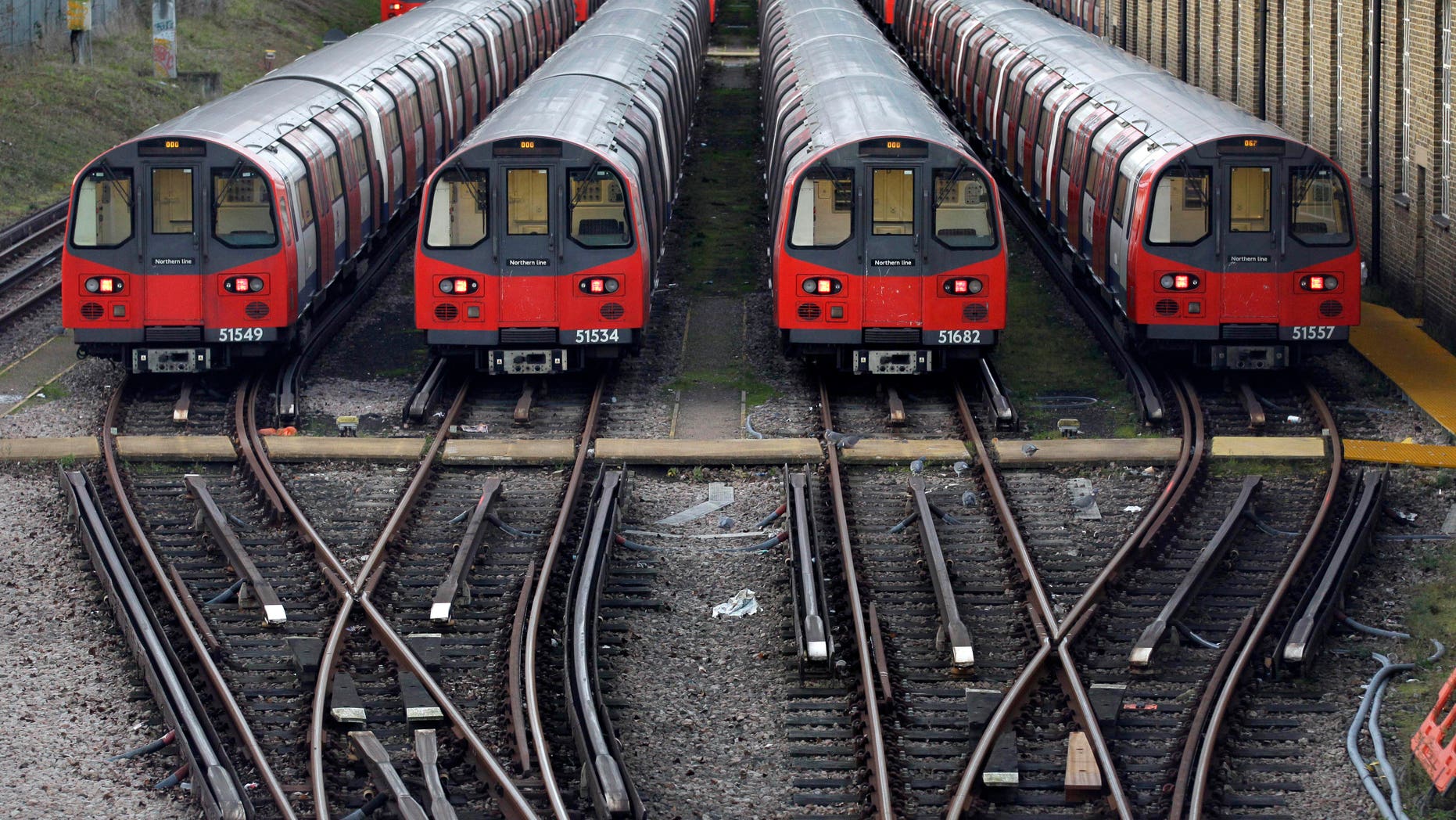 FILE - In this Monday, Dec. 26, 2011 file photo, Underground trains are parked during a 24-hour strike by train drivers over public holiday pay, at Mordern depot, south London. Millions of commuters face travel woes as workers at London’s underground transport network, the Tube, prepare to go on strike. A walkout is scheduled to start later Tuesday, Feb. 4, 2104, through to Thursday, and a second one is due Feb 11-13. (AP Photo/Sang Tan, File)