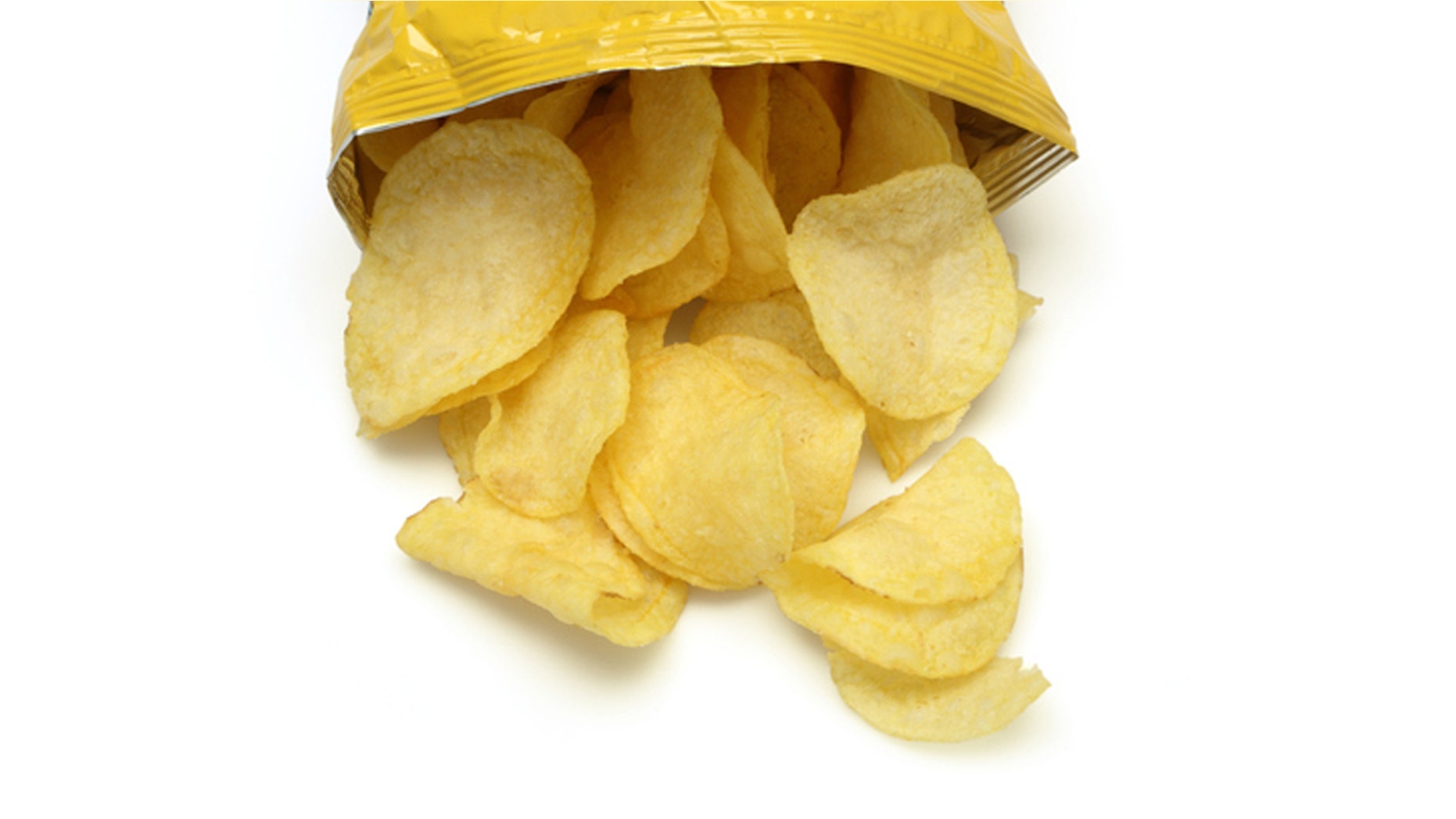 Bag of golden chips isolated on a white background.
