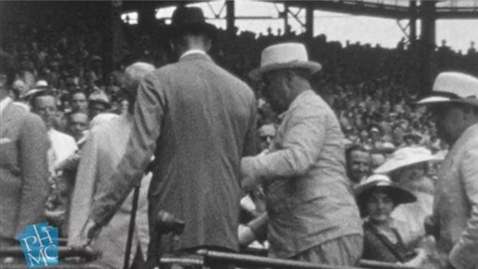 FILE: July 7, 1937: In this image taken from film shot by former Major League Baseball player Jimmie DeShong and acquired by the Pennsylvania Historical & Museum Commission, President Franklin D. Roosevelt, center right, walks to his seat with the aid of an assistant at the Major League Baseball All-Star game at Griffith Stadium in Washington.