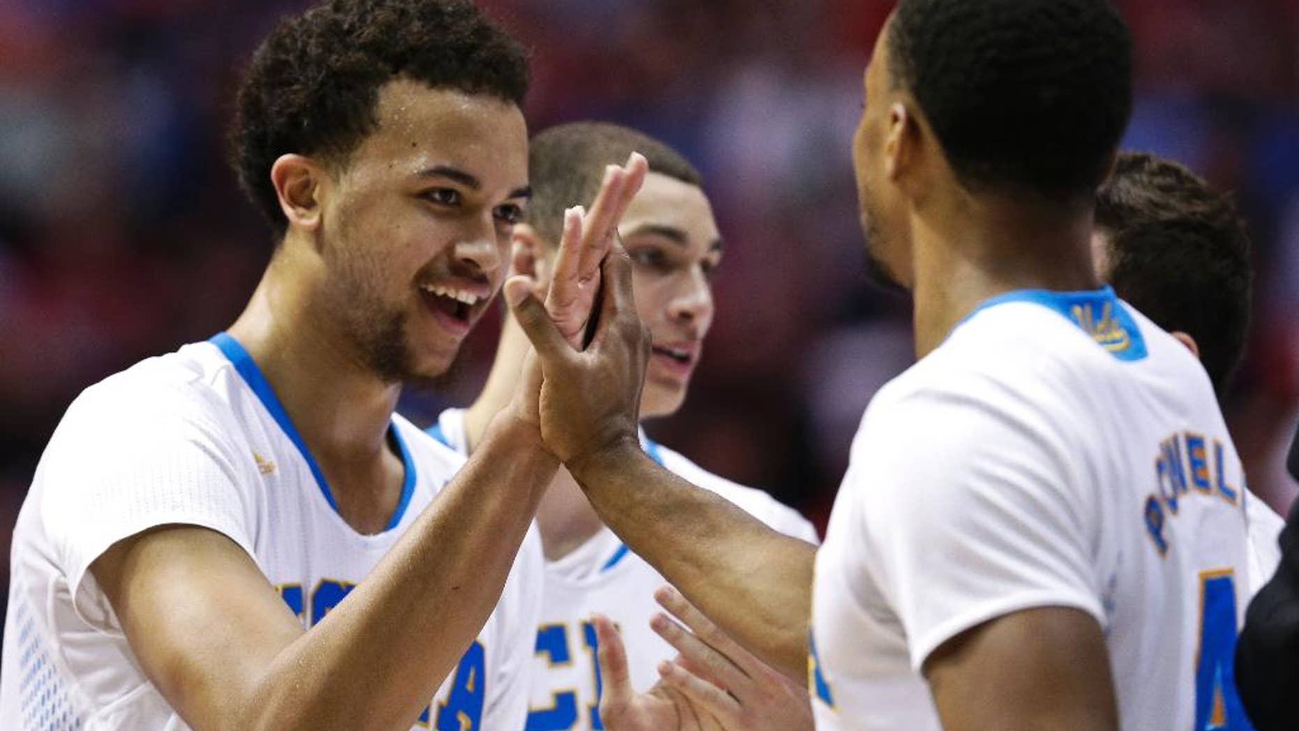 UCLA 's Kyle Anderson and Norman Powell, right, celebrate during the second half of a third-round victory over Stephen F. Austin in the NCAA college basketball tournament, Sunday, March 23, 2014, in San Diego. (AP Photo/Gregory Bull)