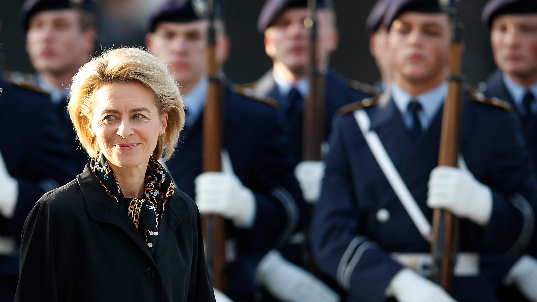 FILE - In this Dec. 17, 2013 file picture German Defense Minister Ursula von der Leyen pass soldiers during an office handing-over ceremony at the defense ministry in Berlin, Germany. Germany’s new defense minister is pledging to make the country’s military more attractive for people with young families as the all-professional force seeks recruits. Ursula von der Leyen, a mother of seven, became Germany’s first female defense minister last month - inheriting an ongoing military overhaul after Germany abandoned conscription in 2011. (AP Photo/Michael Sohn)