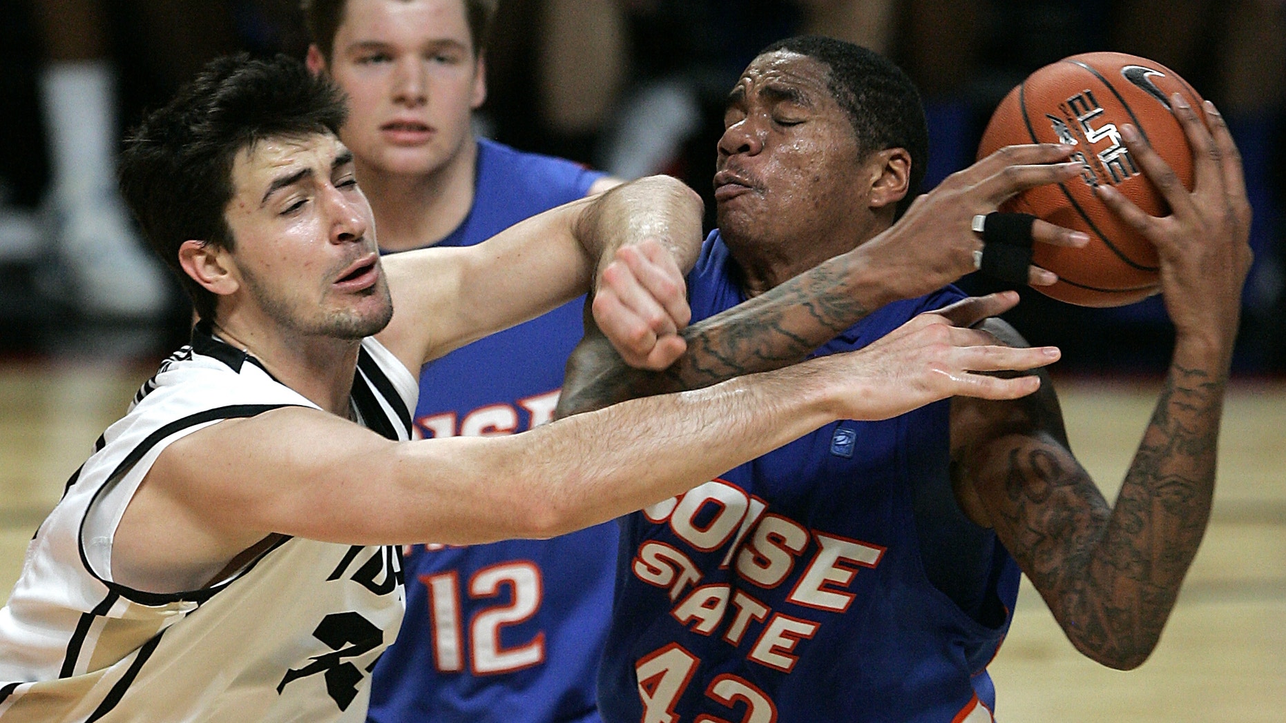 Idaho's Kyle Barone, left, and Boise State's Kenny Buckner (42) go after a loose ball during the first half of an NCAA college basketball game on Thursday, Dec. 20, 2012, in Boise, Idaho. (AP Photo/Matt Cilley)