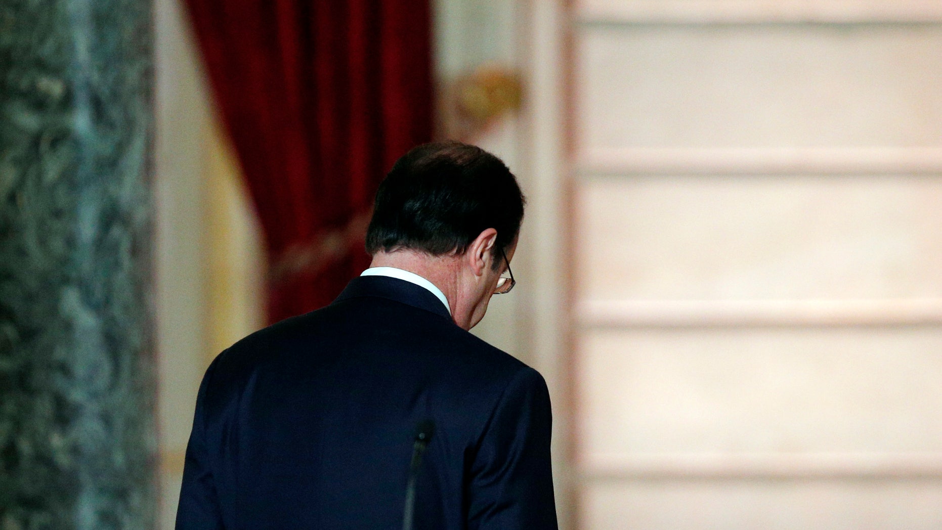 French President Francois Hollande leaves after his annual news conference, Tuesday, Jan.14, 2014 at the Elysee Palace in Paris. Hollande is promising to cut 50 billion euros in public spending over 2015-2017 to try to improve the indebted economy. Hollande, a Socialist, came to office in 2012 on pledges to avoid the painful austerity measures carried out by neighboring Spain and Italy. But France’s economy has suffered two recessions in recent years and growth is forecast at an anemic 0.2 percent in 2013. (AP Photo/Christophe Ena)