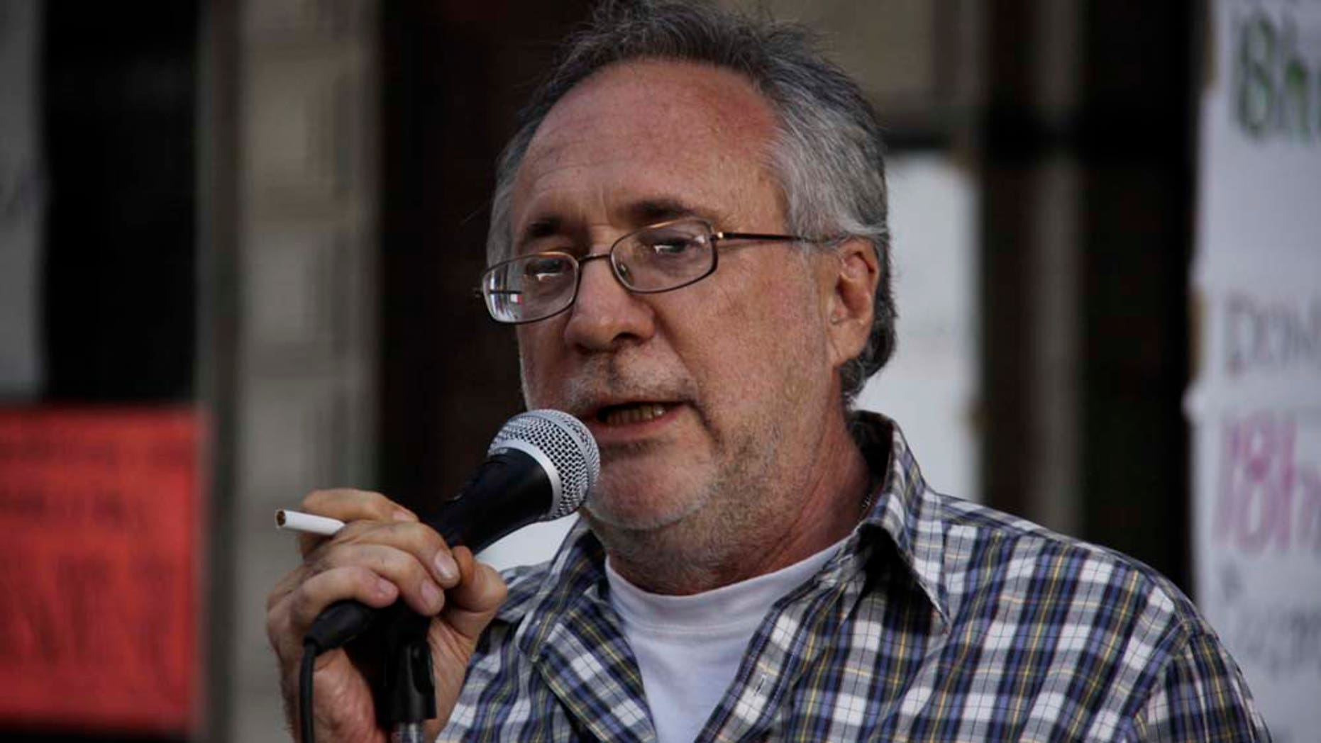 Mexican poet Javier Sicilia reads a poem dedicated to his slain son in downtown Cuernavaca, Mexico, Saturday April 2, 2011. Sicilia's son was found dead inside a car along with six other bodies on March 28 with a warning message left behind. Sicilia says this is the last poem he will ever write because the sorrow from his loss prevents him from further writing. (AP Photo/Antonio Sierra)