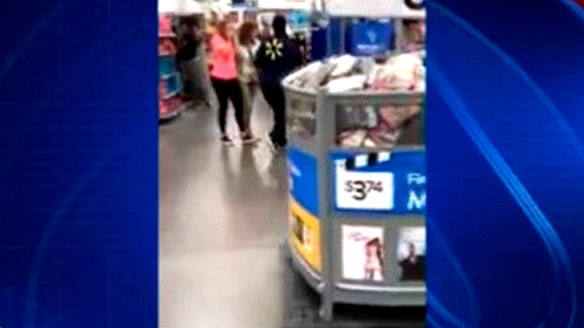 Image from cellphone video shot after woman pulled out a loaded gun at Michigan Walmart