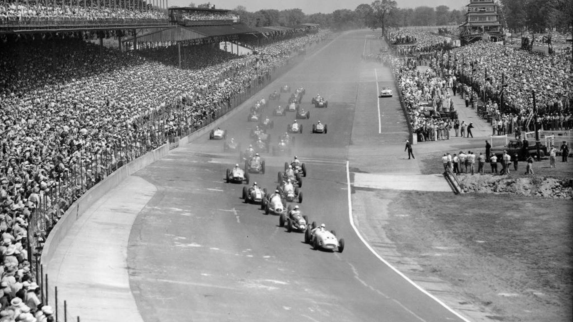 FILE - In this May 31, 1954, file photo, thirty-three competitors approach the first curve of the Indianapolis Motor Speedway in the 38th running of the Indianapolis 500 auto race in Indianapolis, Ind. Pole winner Jack McGrath, right, driving a Hinkle Special, is leading. (AP Photo/File)