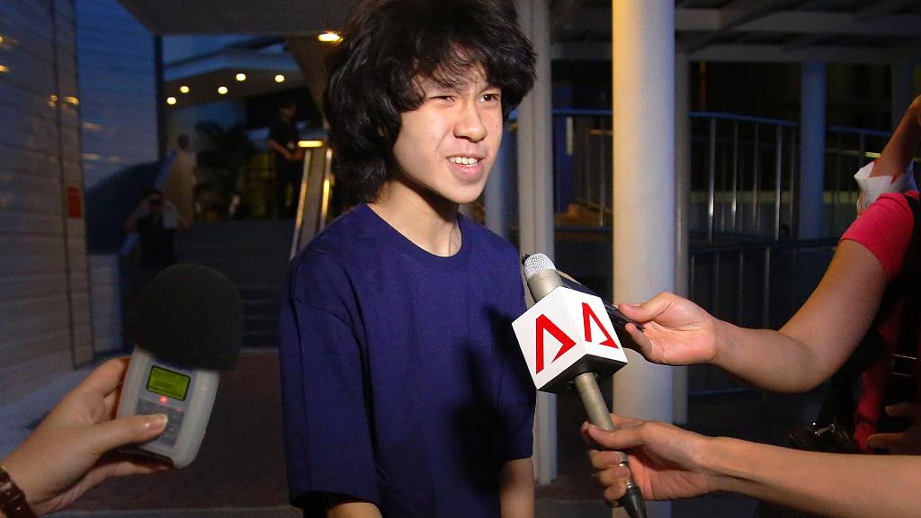 FILE - In this Tuesday, May, 12, 2015, file photo, Singapore teen blogger Amos Yee speaks to reporters while leaving the Subordinate Courts after being released on bail in Singapore. Yee whose video posts and blogs mocking his government and its late founder landed him in jail twice has been detained in the U.S. where he is seeking asylum. Human Rights Watch called on the U.S. to recognize Amos Yee’s asylum claim, saying he has been consistently harassed in Singapore for publicly expressing his views. (AP Photo/Wong Maye-E, File)