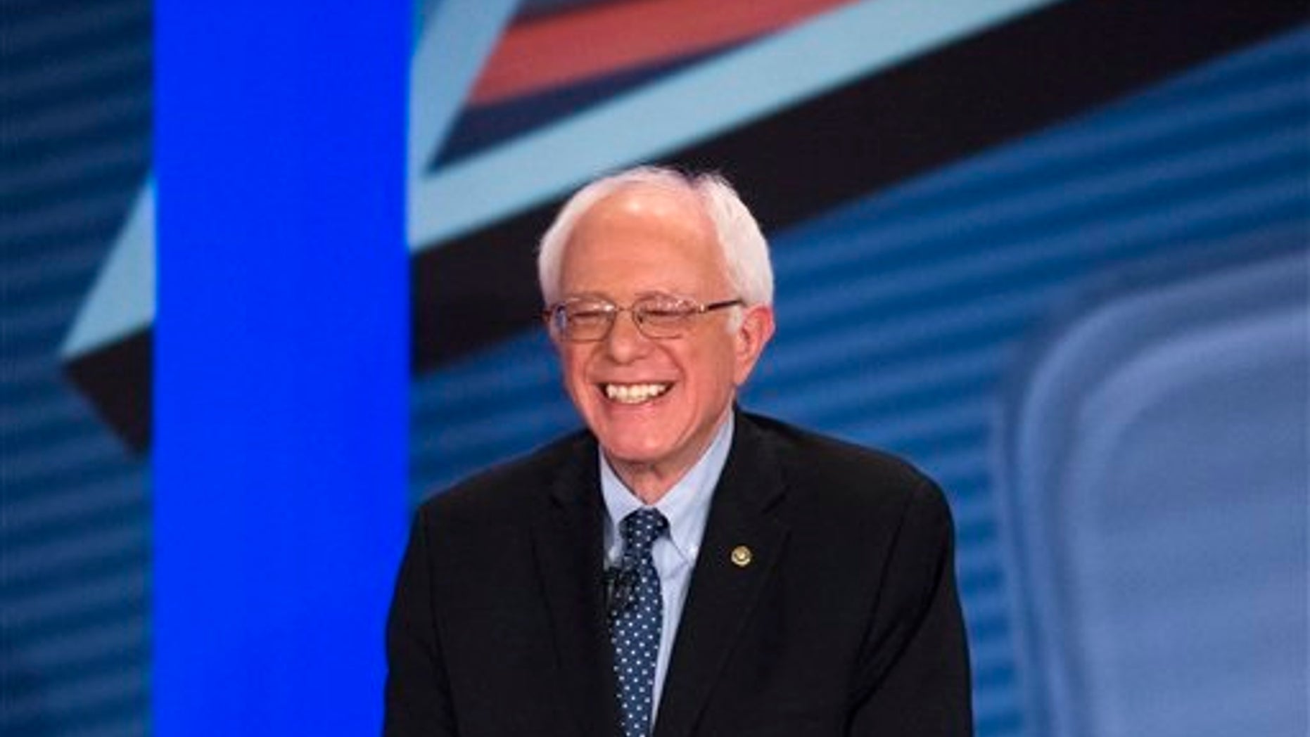 Democratic presidential candidate Sen. Bernie Sanders, I-Vt., smiles as he answers a question from the audience alongside host Anderson Cooper during a democratic primary town hall sponsored by CNN, Wednesday, Feb. 3, 2016, in Derry, N.H. (AP Photo/John Minchillo)