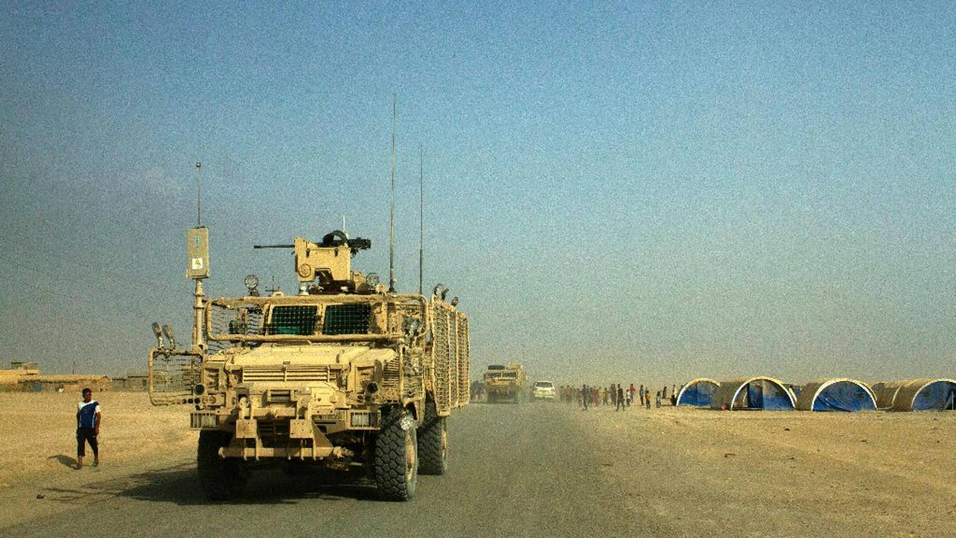 Armored coalition vehicles outside the Qayara air base in August.