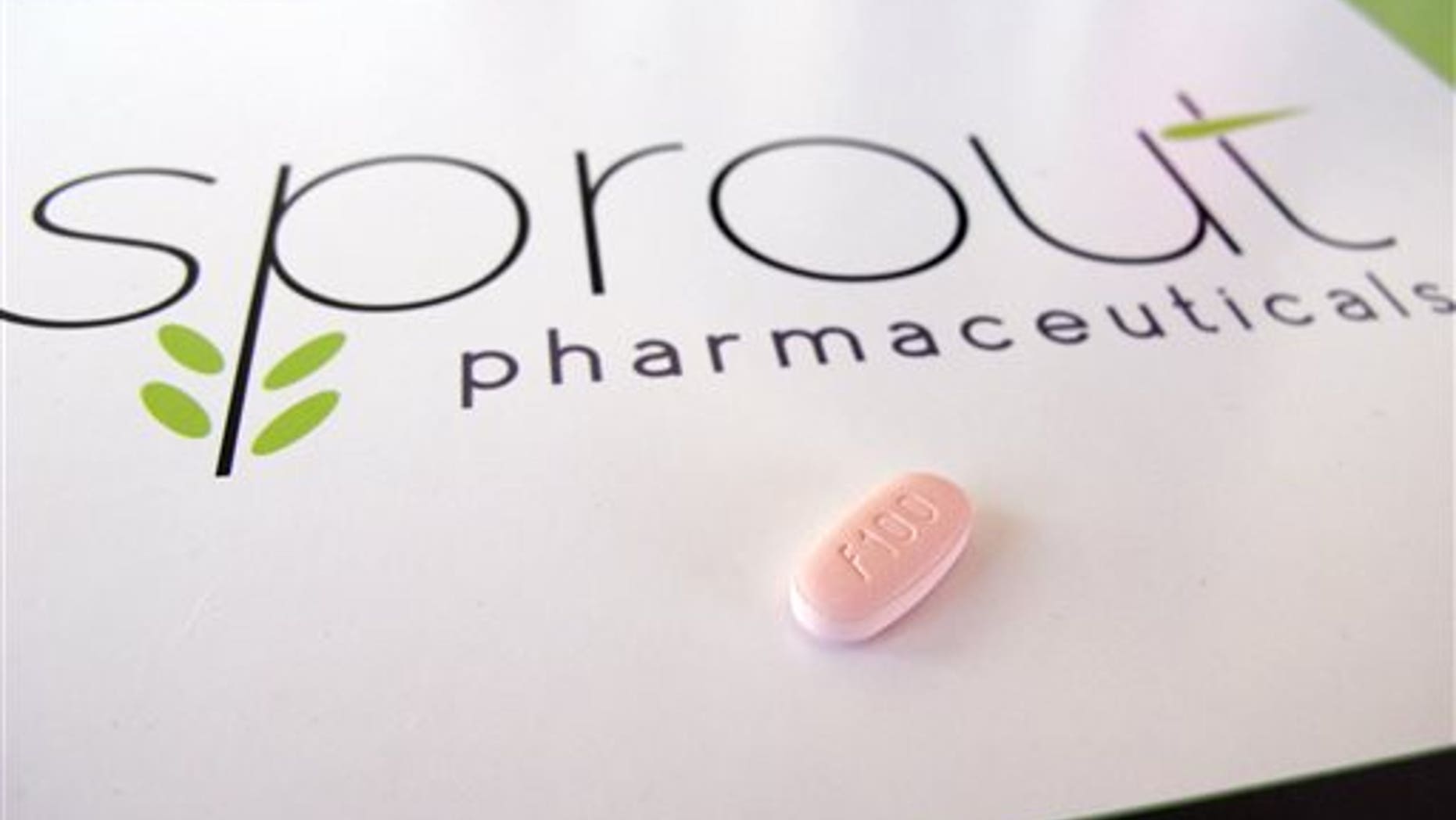 In this June 22, 2015, photo, a tablet of flibanserin sits on a brochure for Sprout Pharmaceuticals in the company's Raleigh, N.C., headquarters. (AP Photo/Allen G. Breed)