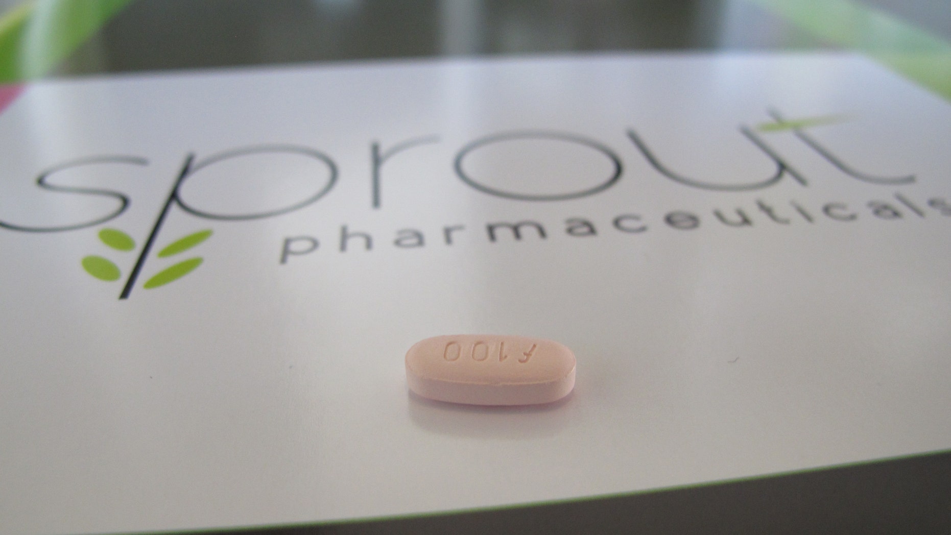 A tablet of flibanserin sits on a brochure for Sprout Pharmaceuticals in the company's Raleigh, N.C., headquarters. (AP Photo/Allen G. Breed)