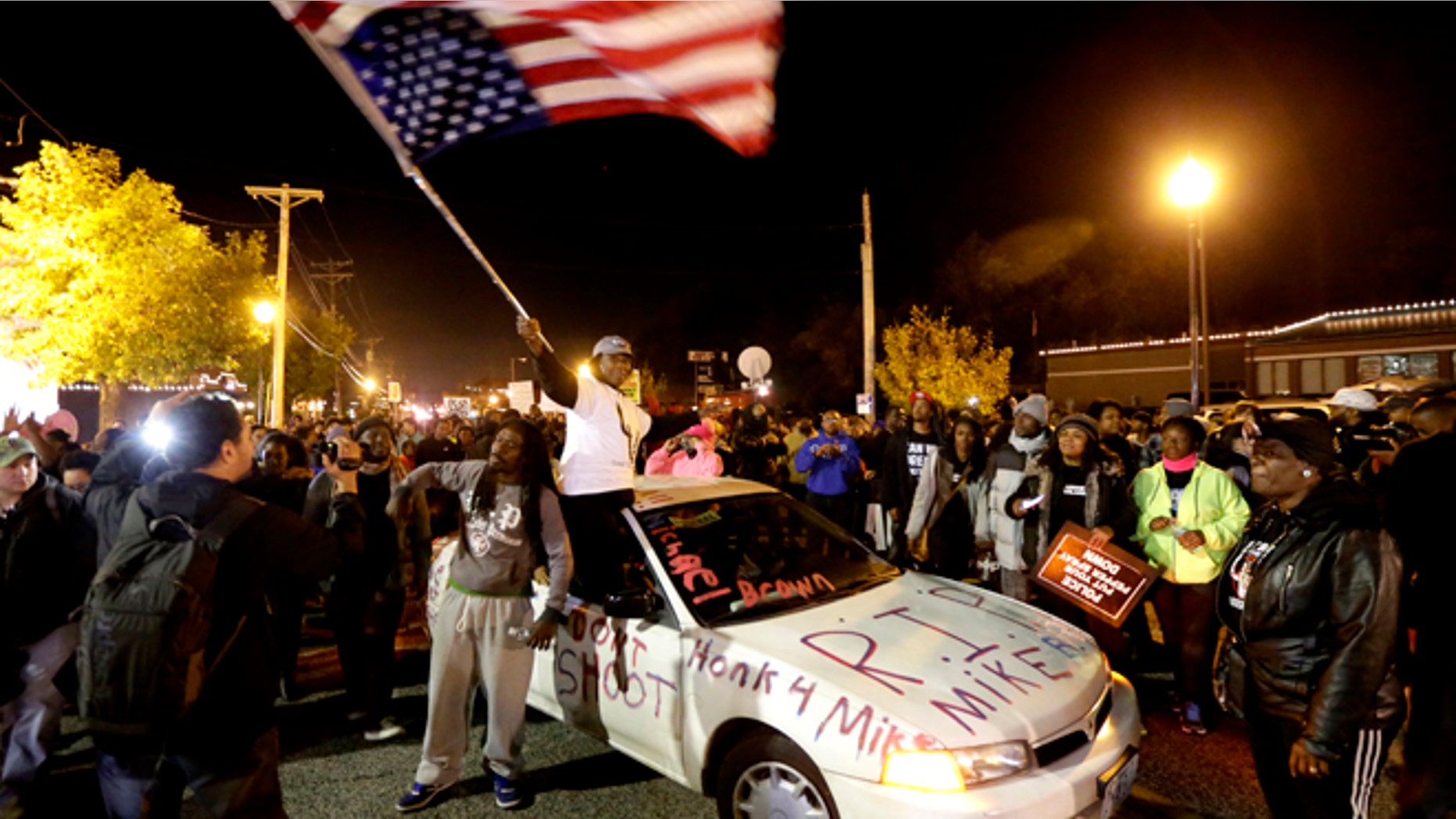 Oct. 11, 2014: Protesters arrive at the Ferguson Police Department for a rally in remembrance of Michael Brown in Ferguson, Mo.