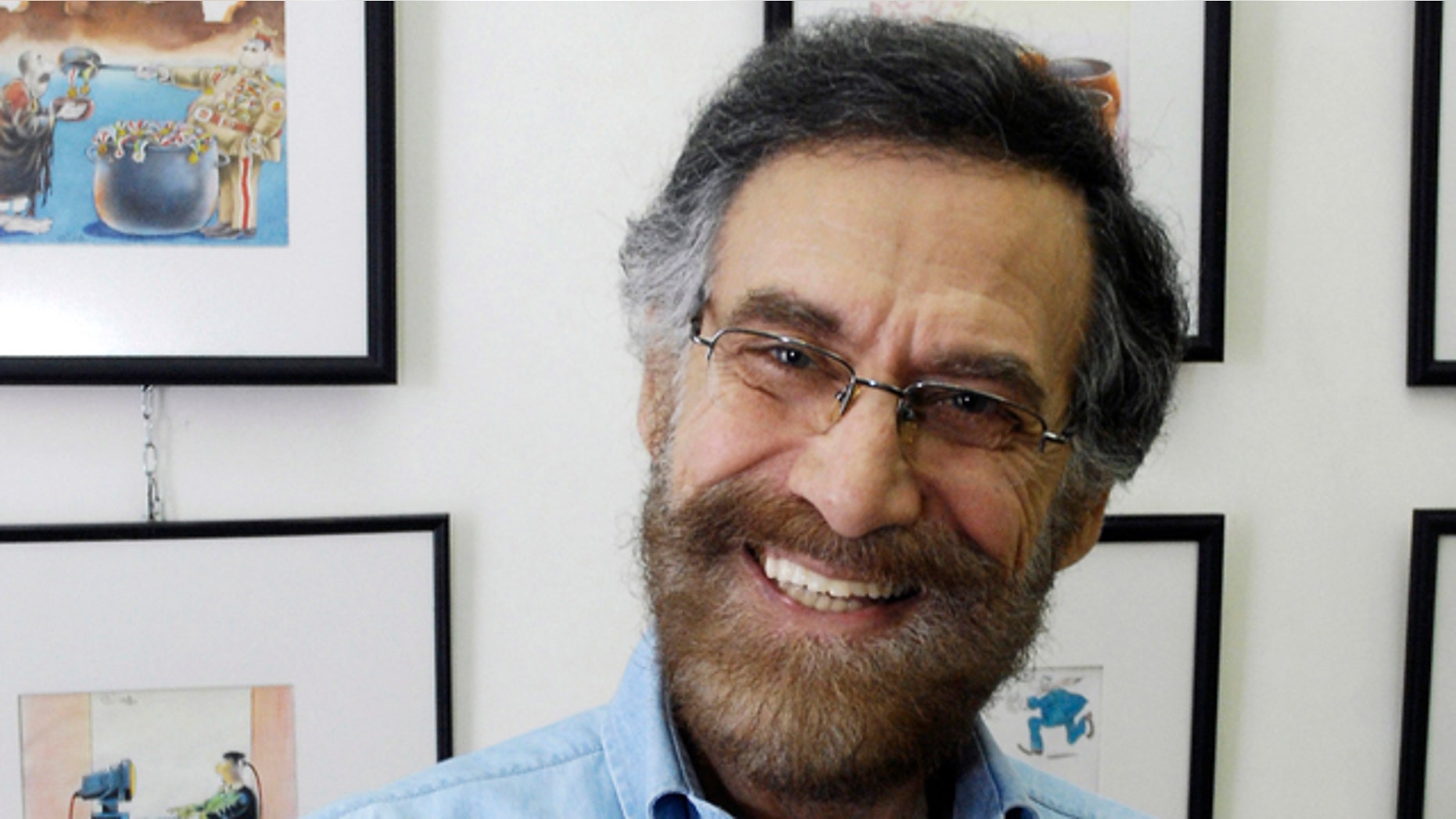 August 14: Syrian cartoonist Ali Farzat poses in his atelier in Damascus, Syria. Syrian security forces attacked renowned anti-regime cartoonist Ali Farzat early Thursday in Damascus and left him bleeding along the side of a road, human rights activists said.