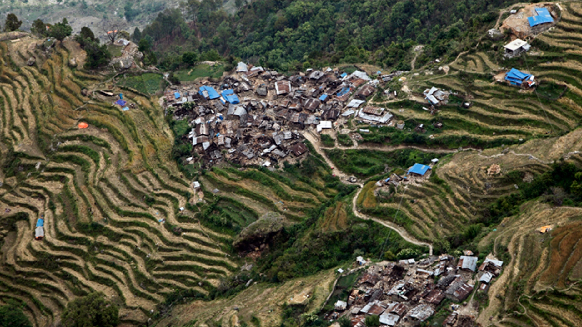 Destroyed villages sit on mountain tops near the epicenter of Saturday's massive earthquake, in the Gorkha District of Nepal, Wednesday, April 29, 2015. Aid reached a hilly district near the epicenter of Nepal's earthquake for the first time Wednesday, four days after the quake struck. (AP Photo/Wally Santana)