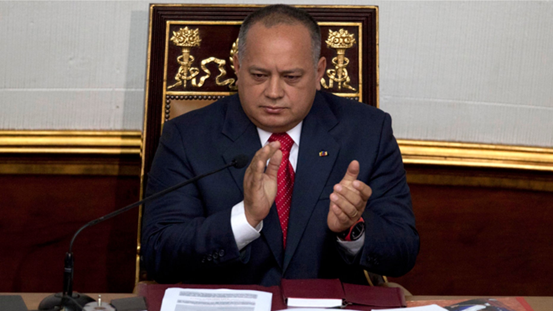 FILE - In this Jan. 5, 2013 file photo, National Assembly President Diosdado Cabello applauds before addressing the National Assembly in Caracas, Venezuela. Cabello said on Wednesday, May 13, 2015 he is asking courts to bar news executives from leaving the country while heâs suing them for alleged defamation. (AP Photo/Ariana Cubillos, File)