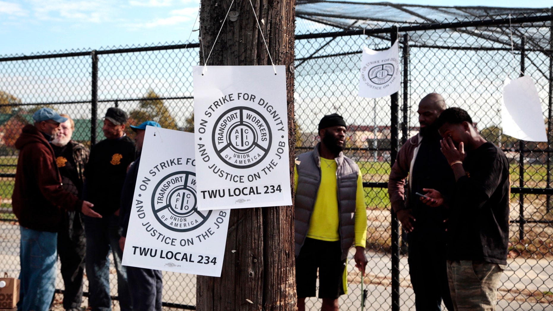 Signs hang on a telephone pole as workers picket across from the Callowhill SEPTA Depot Tuesday, Nov. 1, 2016, in Philadelphia.